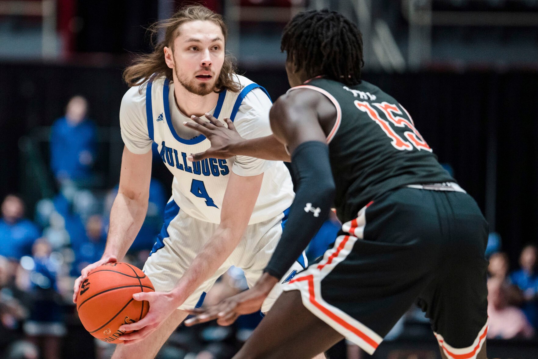 <p>North Carolina-Asheville forward Drew Pember looks to pass against Campbell forward Jay Pal during the Big South Championship on Sunday.</p>