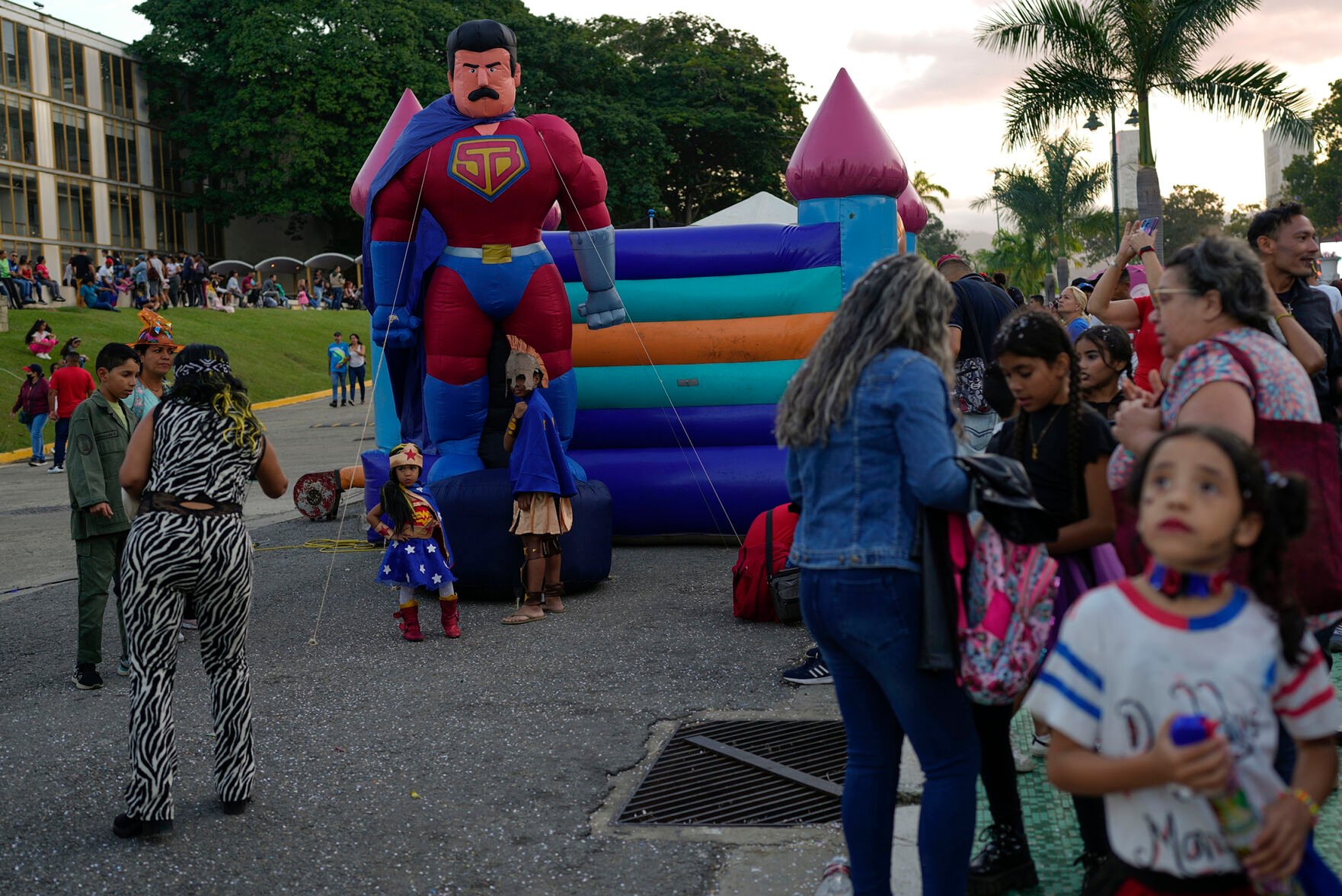 <p>An inflatable doll depicting Venezuelan President Nicolas Maduro as a superhero named “Super Bigote" or Super Mustache, towers over a play area during Feb. 20 carnival celebrations in Caracas, Venezuela.</p>