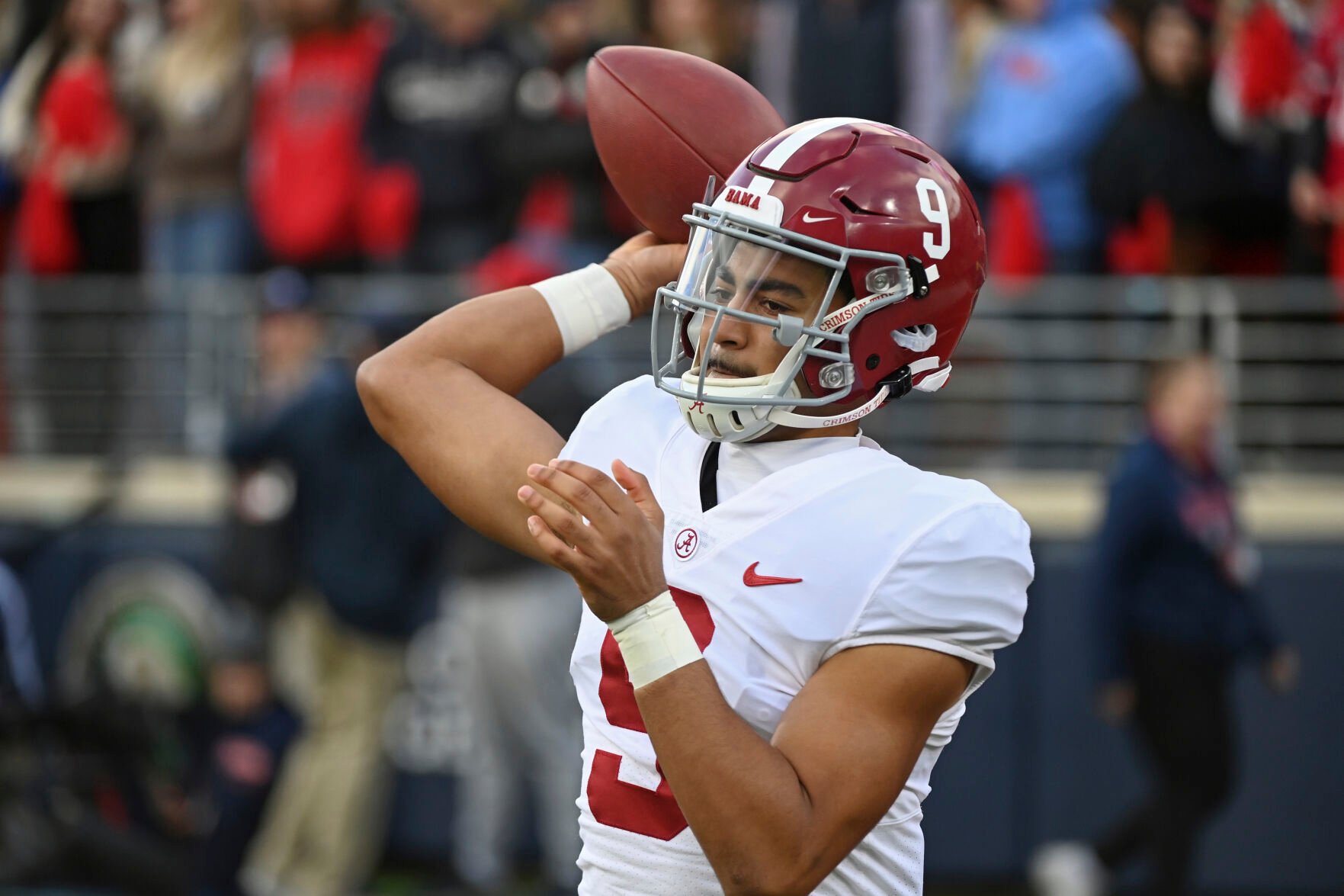 <p>Alabama quarterback Bryce Young warms up on the sidelines during the first half of a Nov. 12 game against Mississippi in Oxford, Miss.</p>
