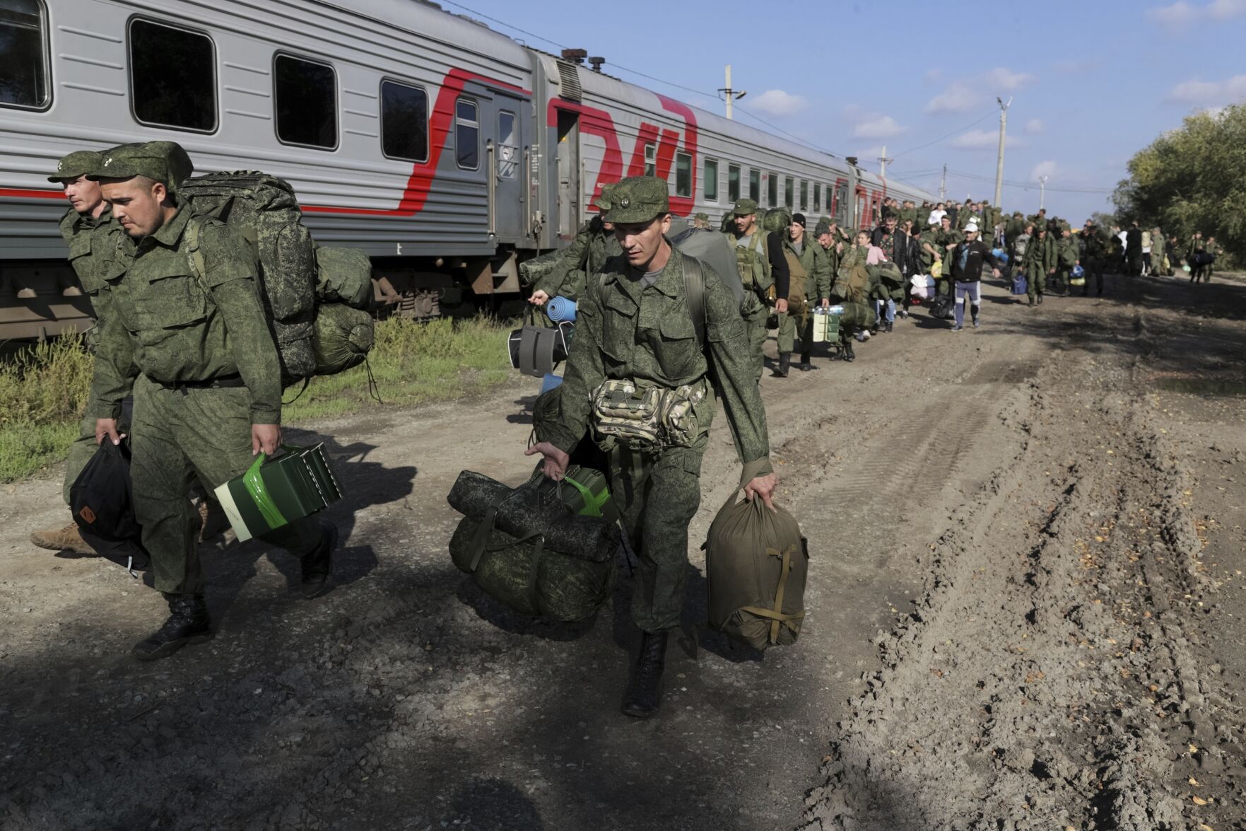 <p>Russian recruits walk to take a train at a railway station Sept. 29, 2022, in Prudboi, the Volgograd region of Russia.</p>