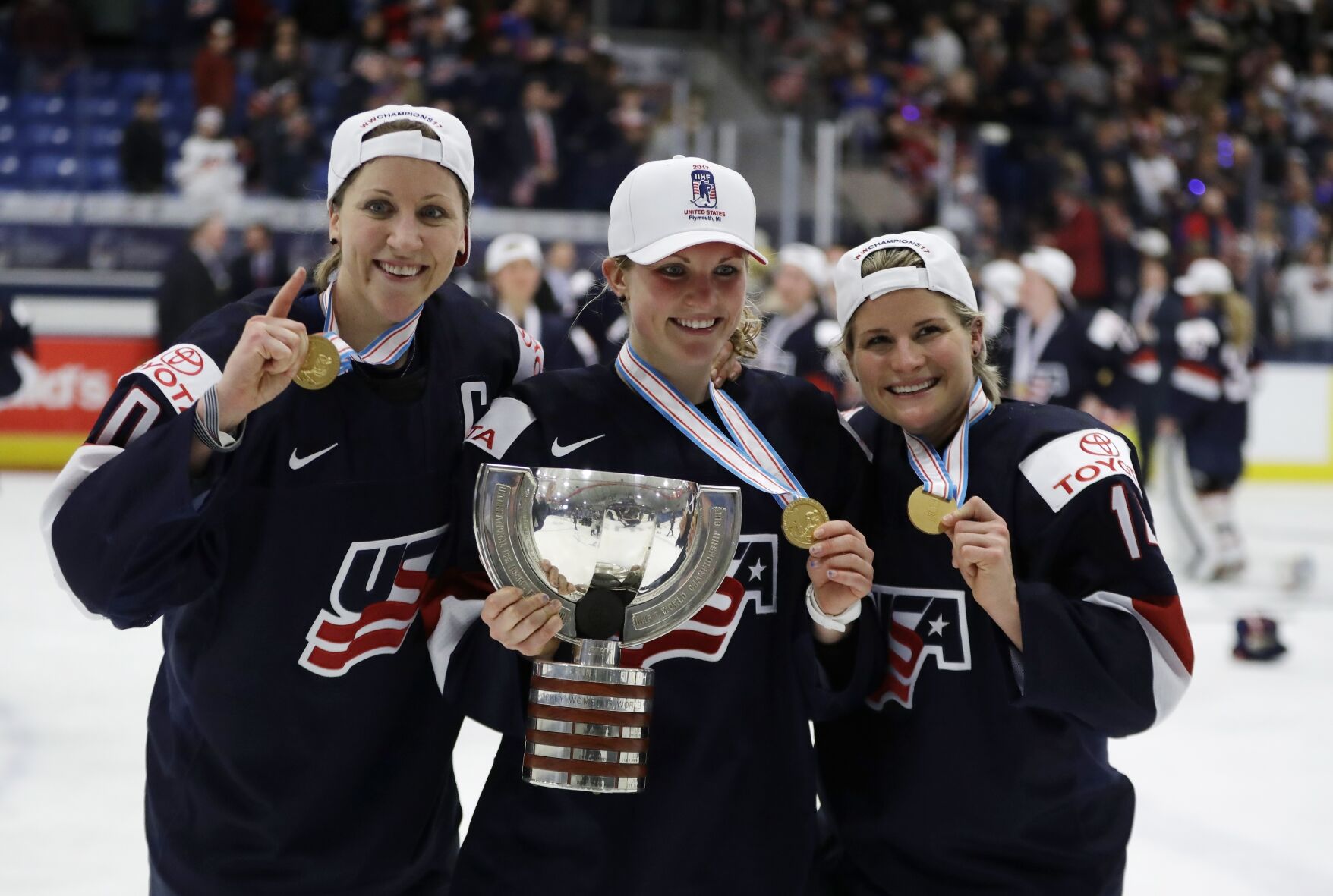 <p>American forward Meghan Duggan, left, defender Monique Lamoureux, center, and forward Brianna Decker pose with the winner's trophy after the team defeated Canada 3-2 in overtime in the 2017 world hockey championships in Plymouth, Mich.</p>