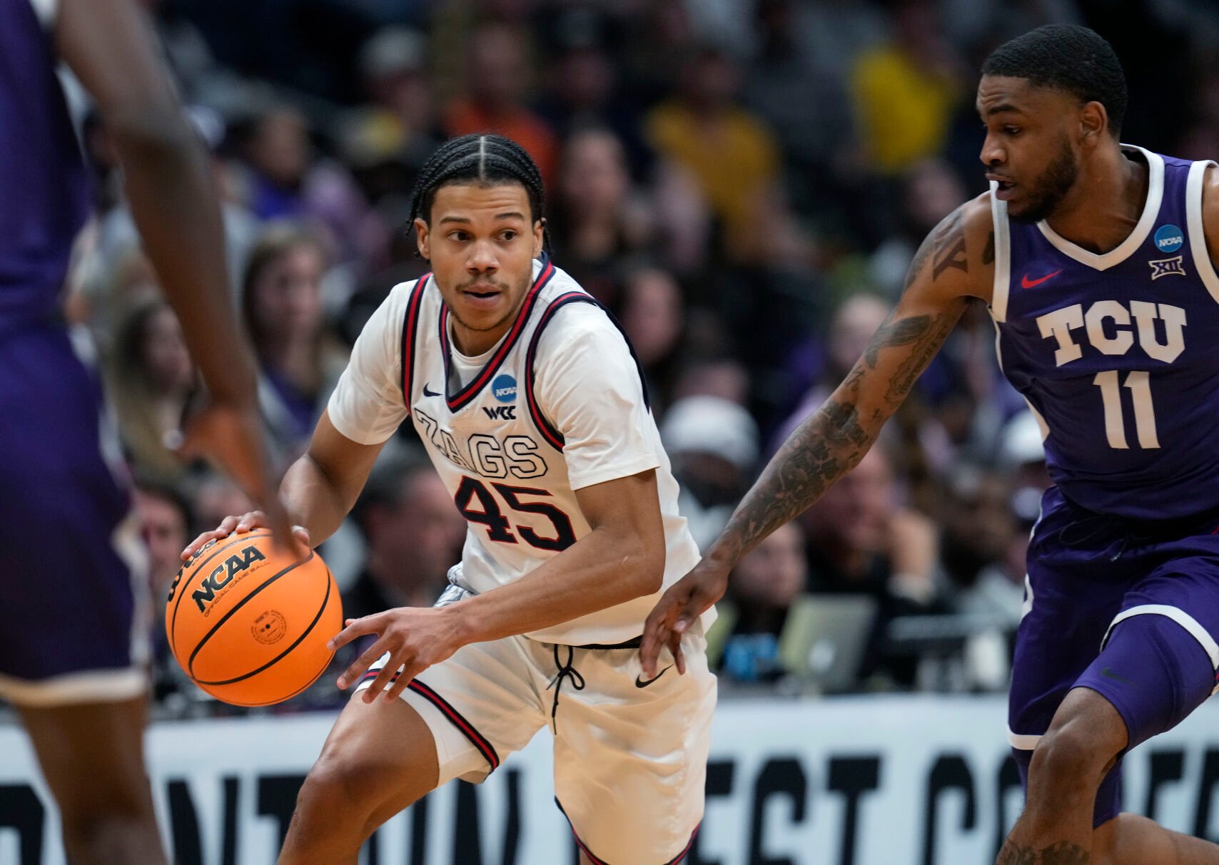 <p>Fifth-year Gonzaga guard Rasir Bolton looks to drive past TCU guard Rondel Walker during their second-round game in the men's NCAA Tournament on Sunday.</p>