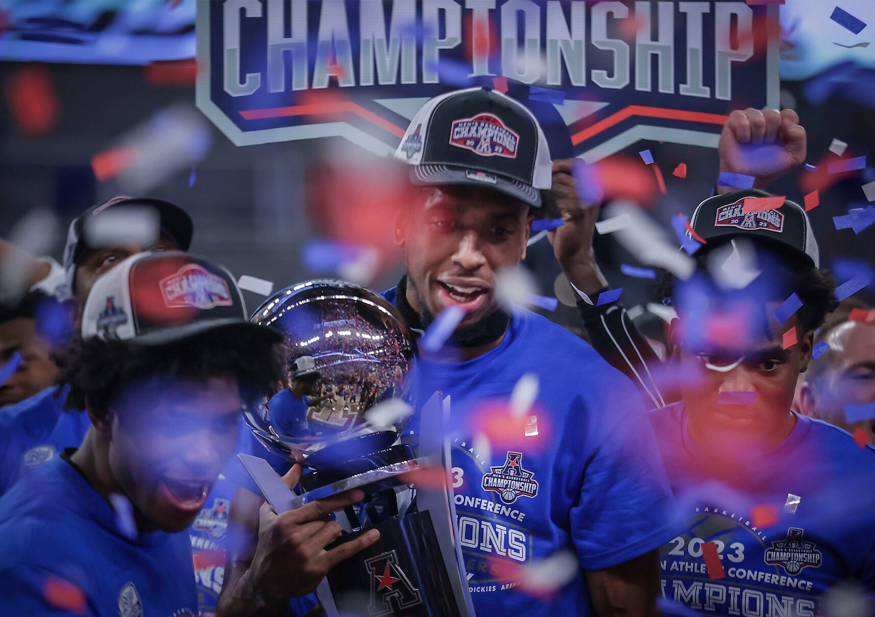 <p>Memphis forward DeAndre Williams holds the trophy after beating Houston in the title game of the American Athletic Conference Tournament on Sunday.</p>