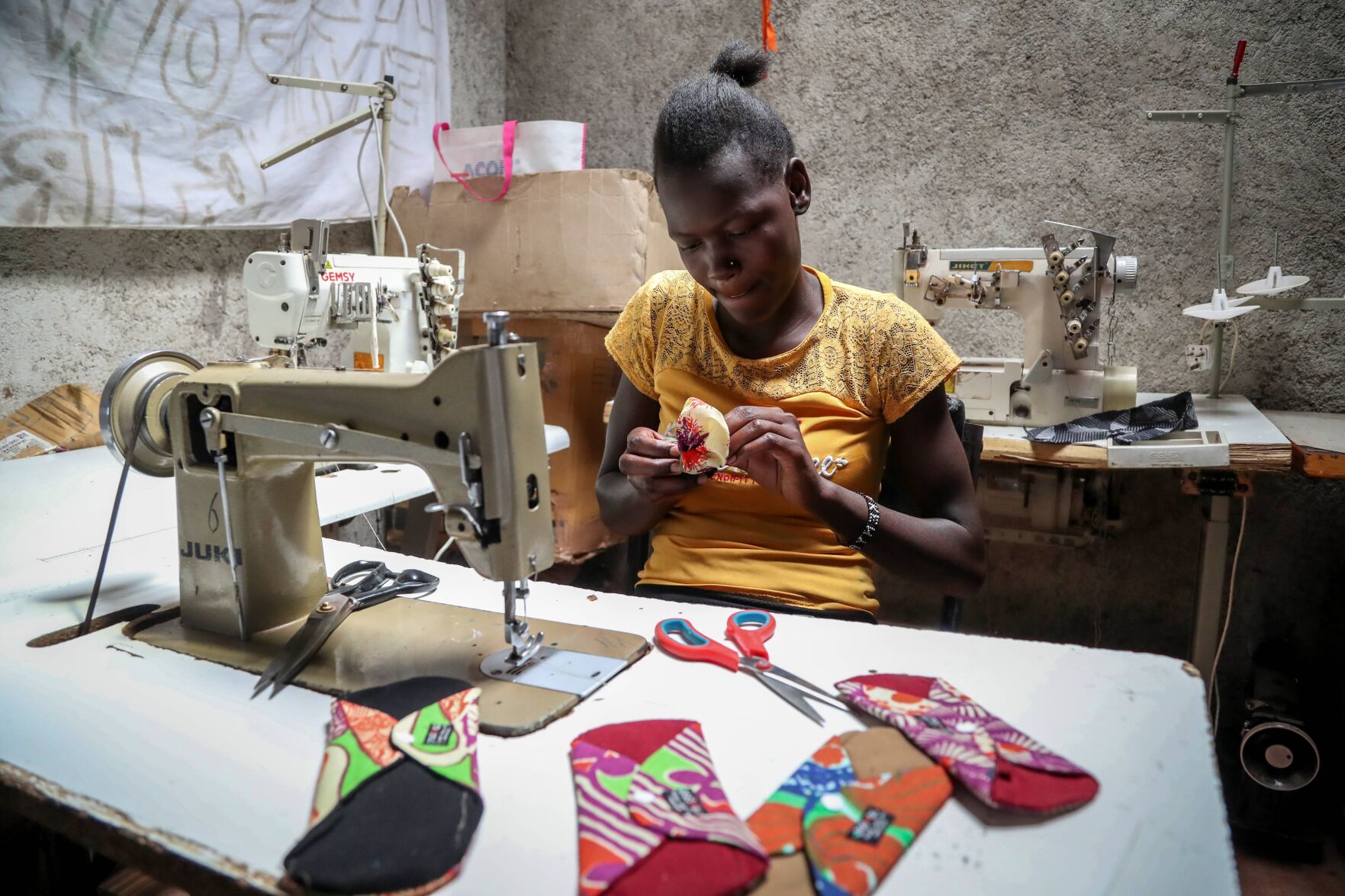 <p>Winnie Adhiambo makes reuseable sanitary pads at Amani Kibera Community Centre on March 7 in the Kibera neighborhood of Nairobi, Kenya.</p>