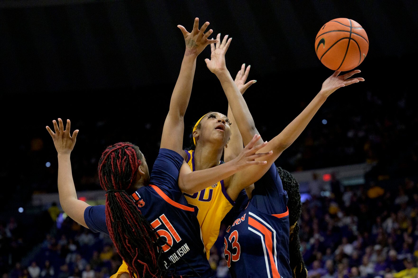 <p>LSU guard Angel Reese, shoots between a double team of Auburn center Precious Johnson (51) and forward Kharyssa Richardson during a Jan. 15 game.</p>