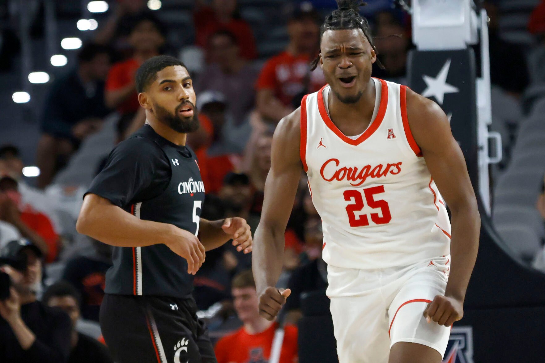 <p>Houston forward Jarace Walker reacts after a dunk as Cincinnati guard David DeJulius looks on during the second half of Sunday's American Athletic Conference semifinal against Cincinnati in Fort Worth, Texas.</p>