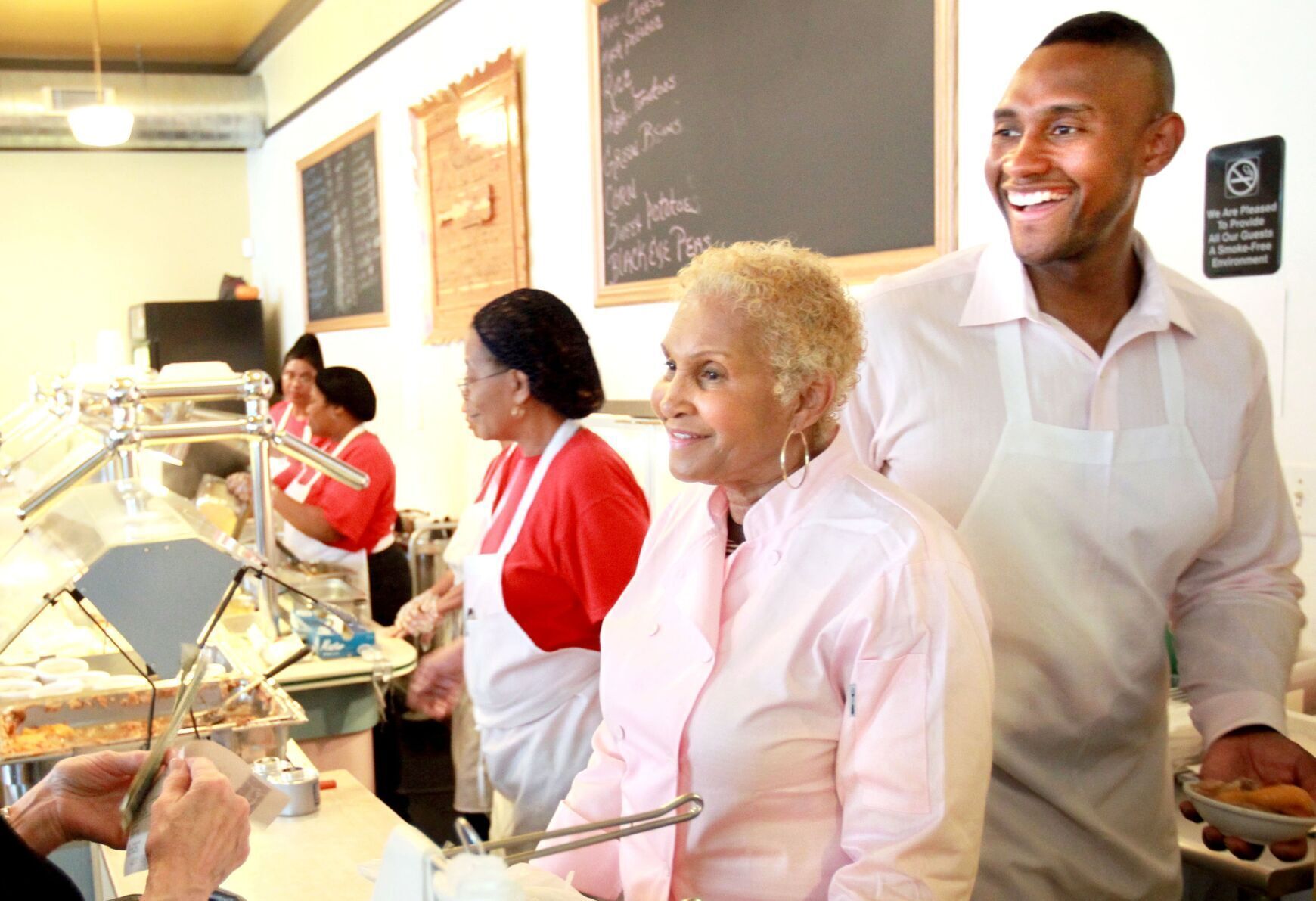 <p>Sweetie Pies’ owner Robbie Montgomery, second from right, and her son Tim Norman, far right, assist a customer in April, 2011 at the restaurant in St. Louis.</p>