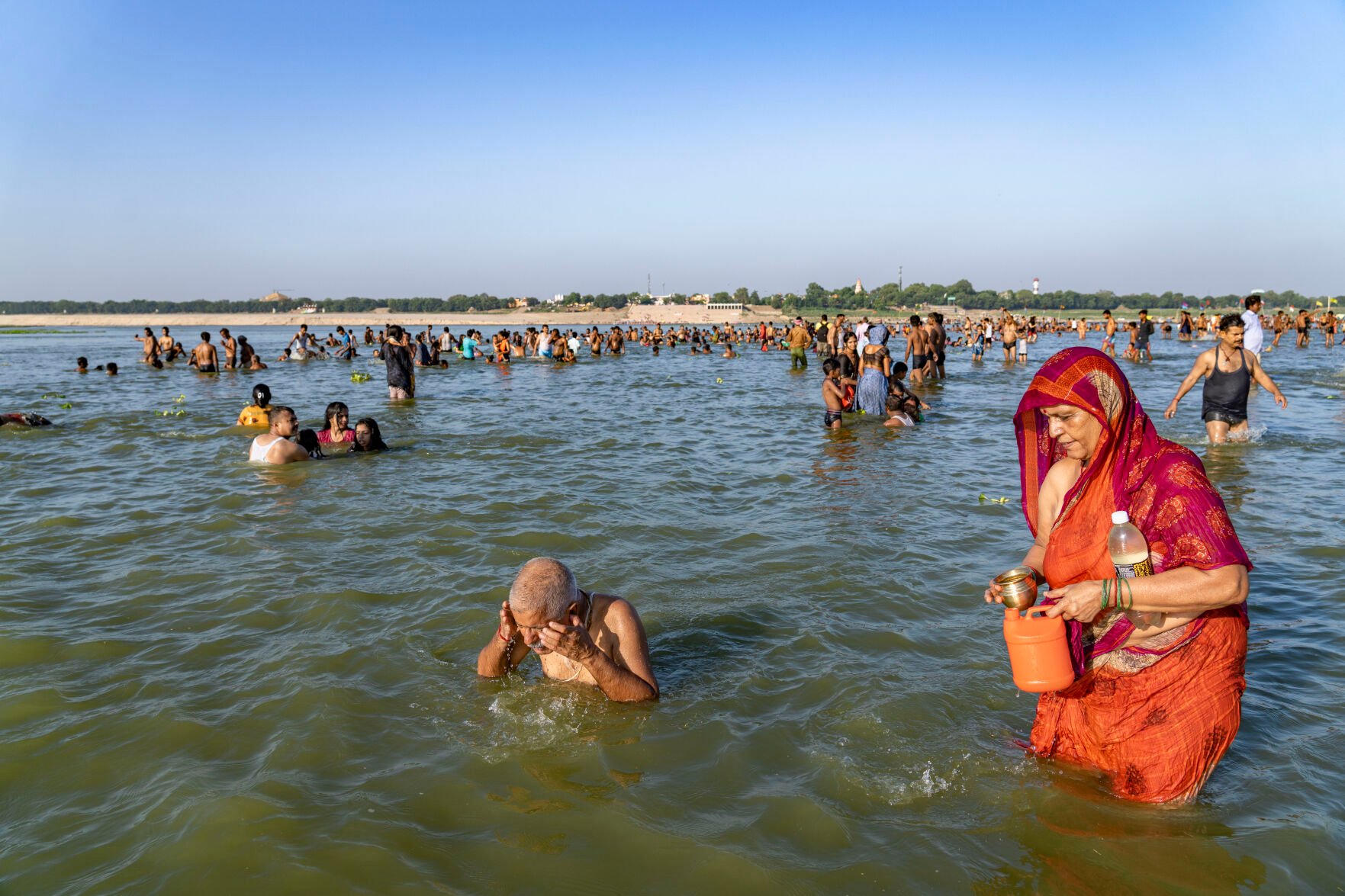<p>Hindu devotees bathe and perform morning rituals July 10 during Devshayani Ekadashi, an auspicious day for devotees of Hindu god Vishnu, in Prayagraj, Uttar Pradesh state, India. In Hinduism, fasting is a voluntary act of spiritual purification.</p>