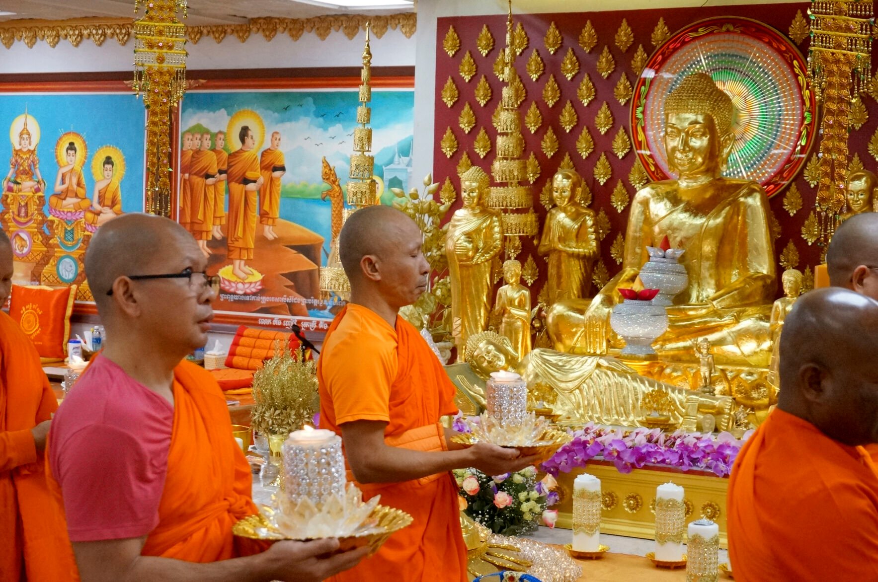 <p>Monks carry candles in front of an altar Feb. 4 Feb. 4 at Watt Munisotaram in Hampton, Minn., to mark the Buddhist holiday of Magha Puja. Buddhist monks generally refrain from taking solid food after noon every day.</p>