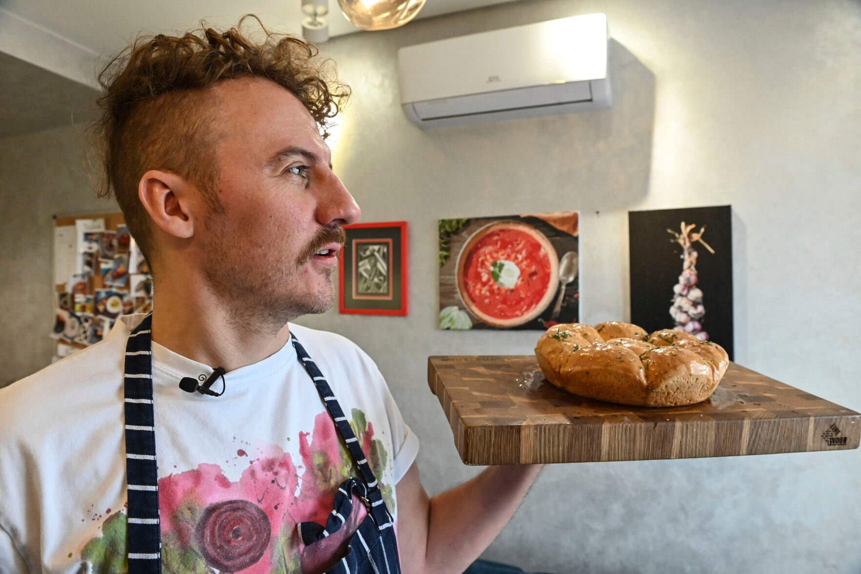 <p>Ukrainian chef Ievgen Klopotenko poses with a tray of Pampushky bread in his kitchen on Feb. 5 in Kyiv, Ukraine.</p>