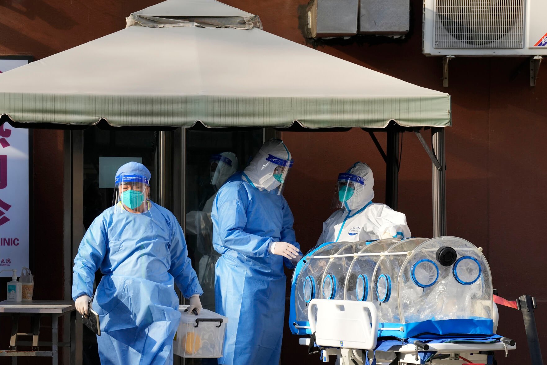 <p>Medical workers in protective gear prepare equipment outside a fever clinic at a hospital Dec. 9, 2022, in Beijing. </p>