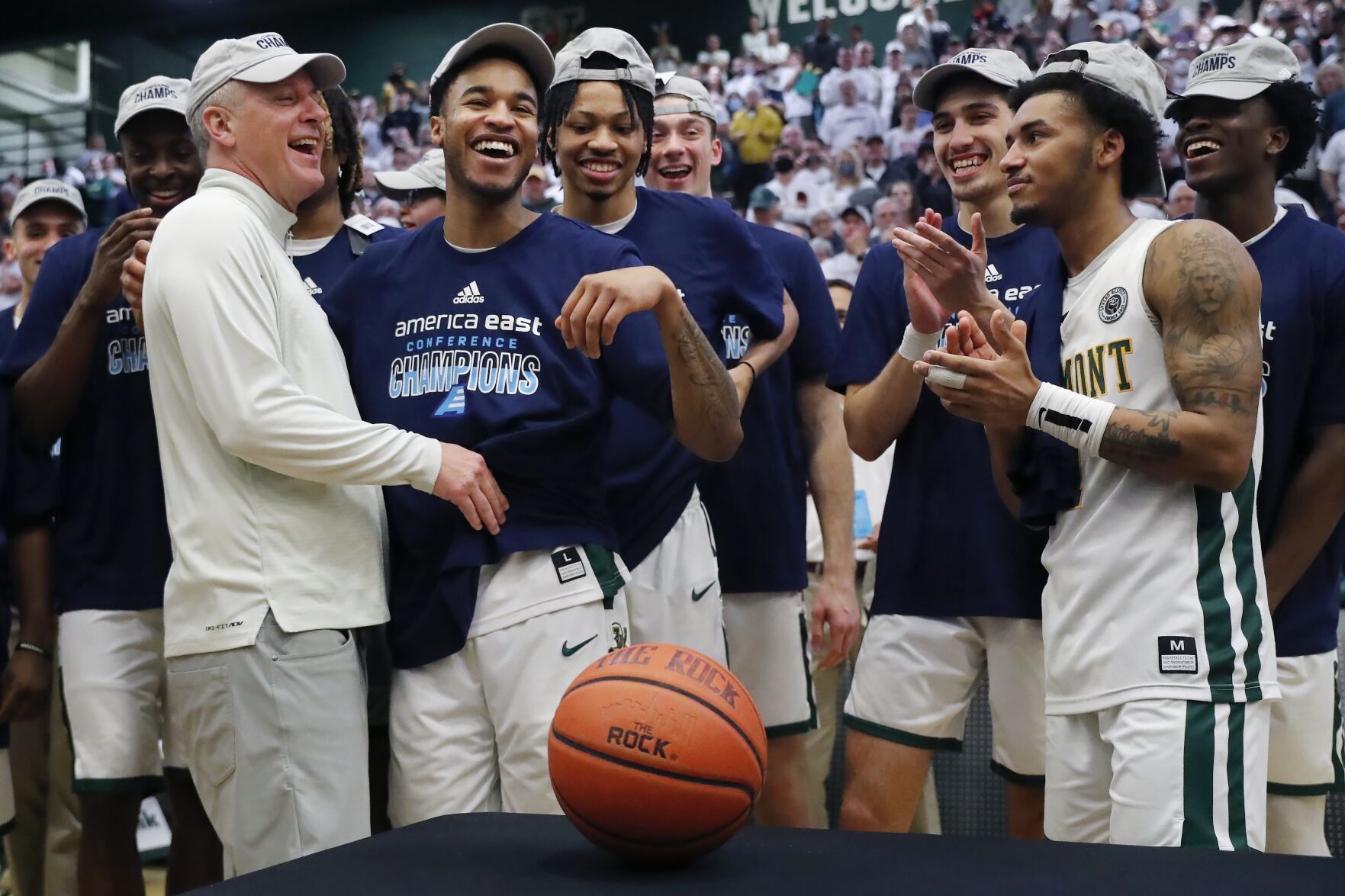 <p>Vermont head coach John Becker, left, celebrates with his team after defeating UMass Lowell in Saturday's America East Conference championship game in Burlington, Vt.</p>