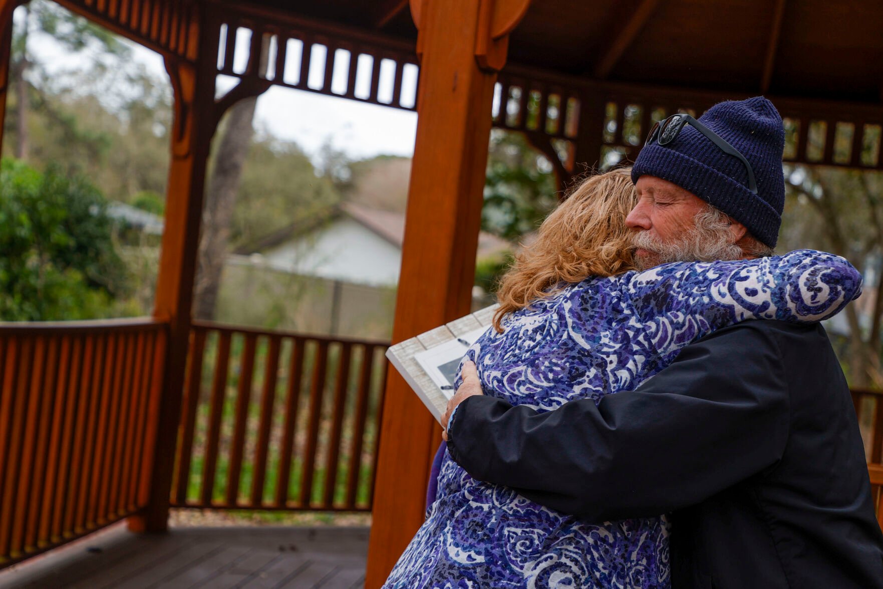 <p>Gary Sawtelle, right, hugs Laura McCullough before she uses the wind phone. He helped her get the booth built and has called his mom and nephew on it. Every week, says, people come to talk to lost loved ones.</p>