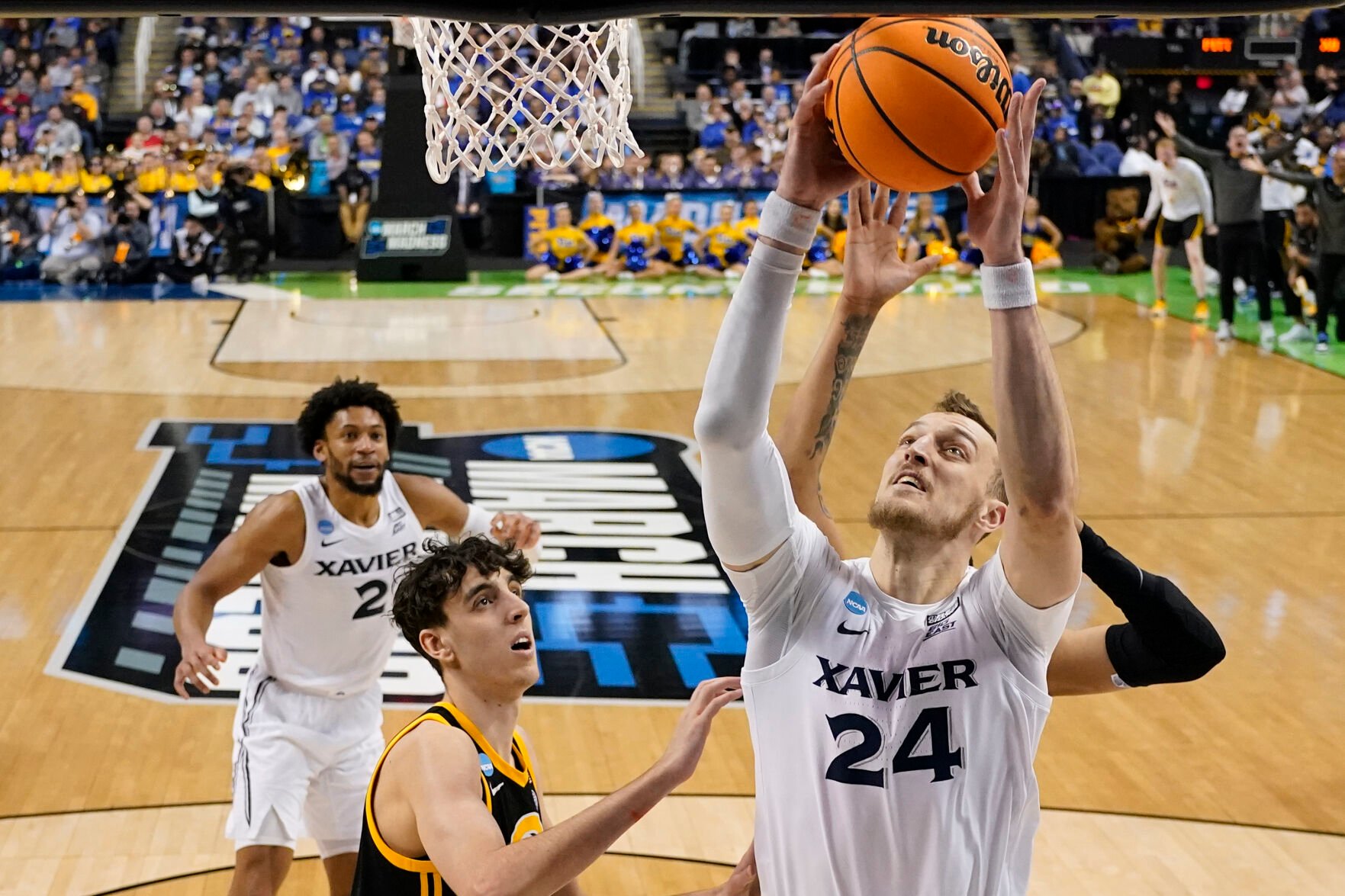 <p>Xavier forward Jack Nunge, right, scores against Pittsburgh forward Guillermo Diaz Graham during a second-round NCAA Tournament game on Sunday in Greensboro, N.C.</p>