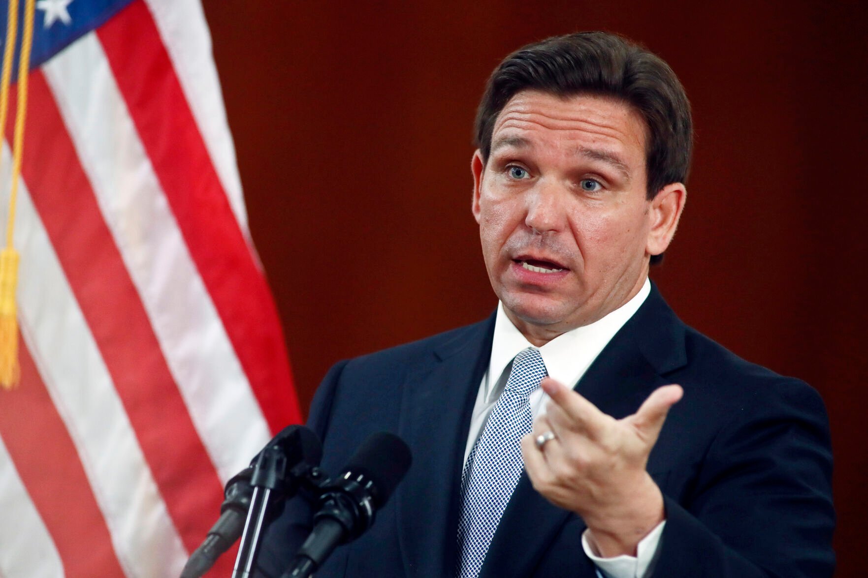 <p>FILE - Florida Gov. Ron DeSantis answers questions from the media in the Florida Cabinet following his State of the State address during a joint session of the Senate and House of Representatives Tuesday, March 7, 2023, at the Capitol in Tallahassee, Fla. On Friday, March 10, The Associated Press reported on stories circulating online incorrectly claiming DeSantis wants bloggers to register with the state or face fines. (AP Photo/Phil Sears, File)</p>