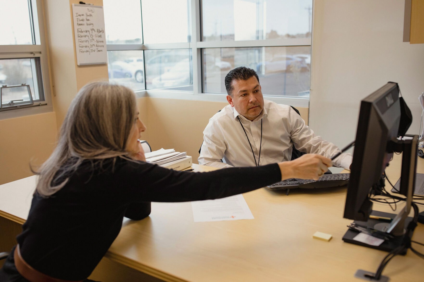 <p>Assistant administrator and lab manager Frank Tenorio listens as administrator Christina Campos goes over legislation for rural hospital designations at Guadalupe County Hospital in Santa Rosa, New Mexico.</p>