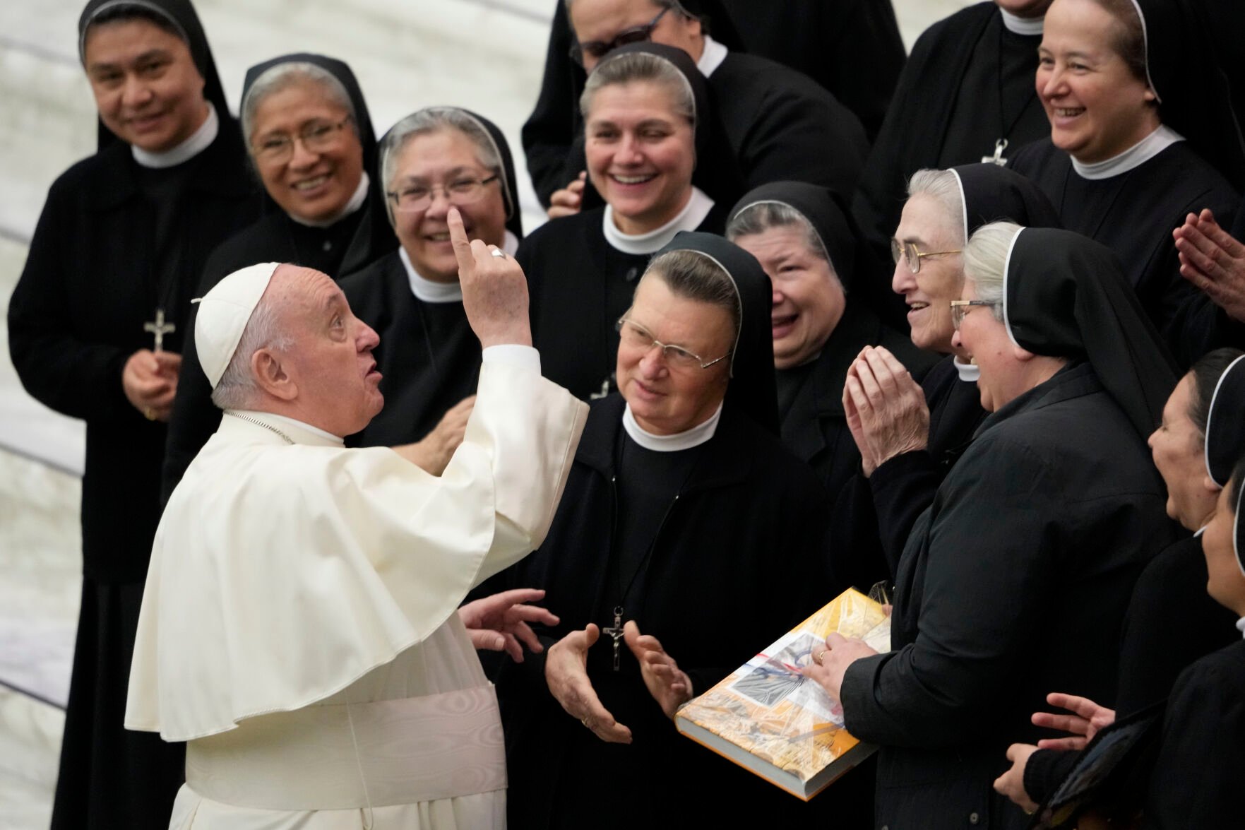 <p>Pope Francis salutes a group of nuns Nov. 24, 2021, at the end of his weekly general audience in the Paul VI Hall the Vatican.</p>