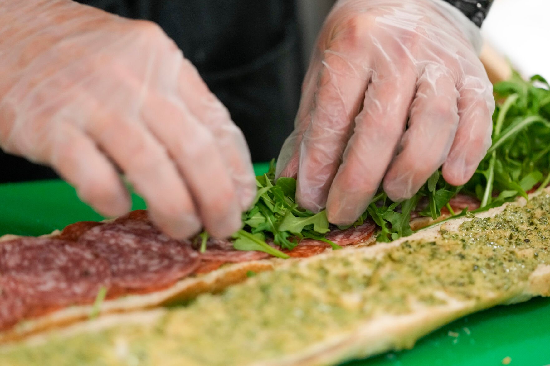 <p>Chef Josh Gjersand prepares a sandwich with homemade pesto aioli and layered with Toscano salami, Monterey Jack and fresh arugula on Jan. 13 at Mount Diablo High School in Concord, Calif.</p>