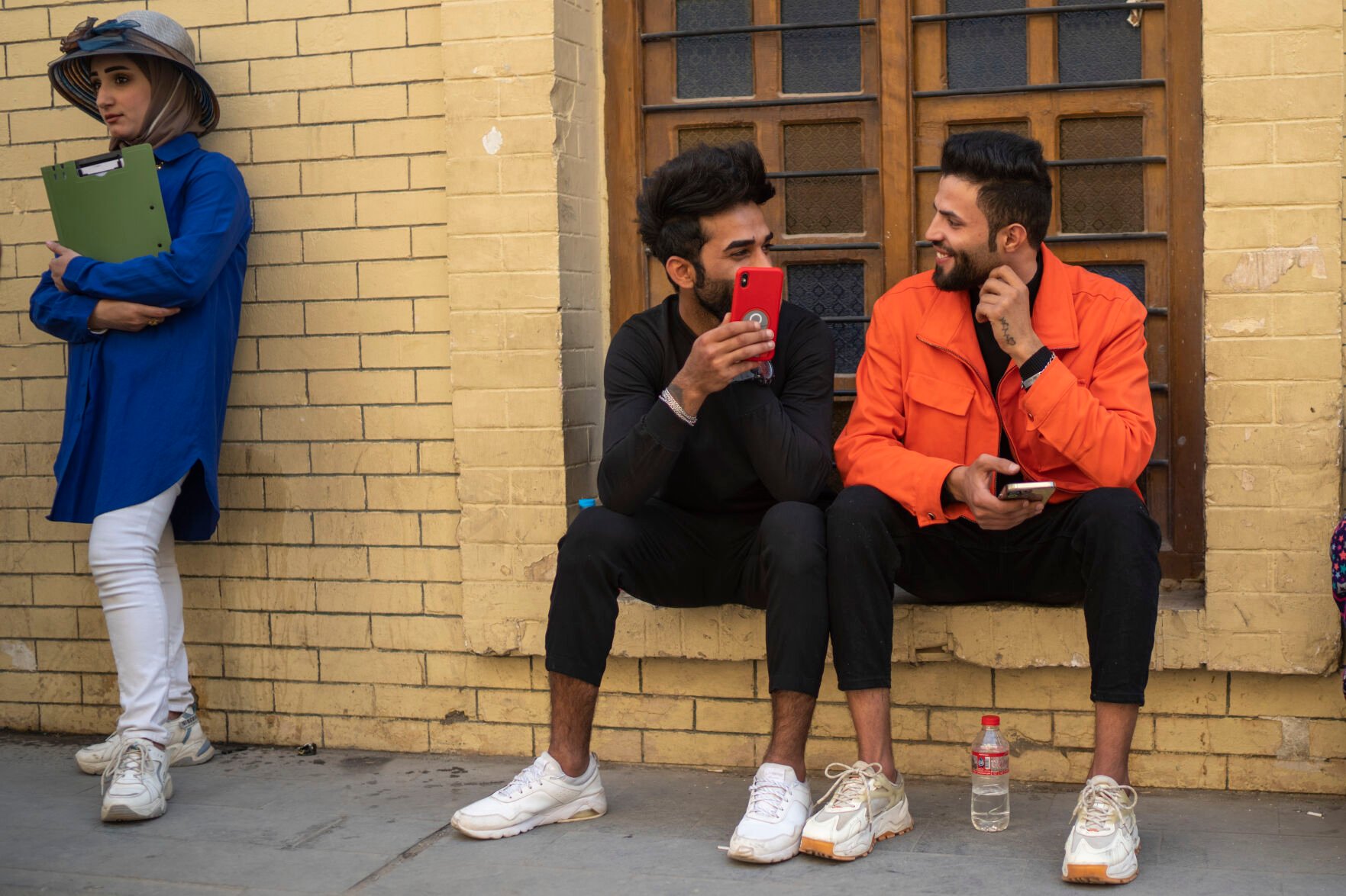 <p>Young men chat near Al-Mutanabbi street in Baghdad, Iraq, Friday, Feb. 24, 2023. Two decades after a U.S.-led invasion, Iraq’s capital today is full of life and a sense of renewal, its residents enjoying a hopeful, peaceful interlude in a painful modern history. (AP Photo/Jerome Delay)</p>