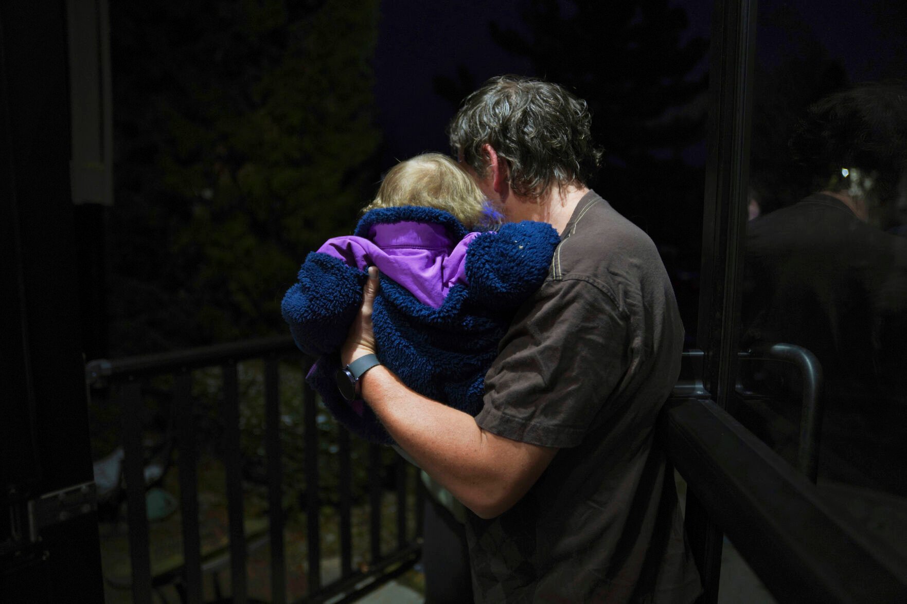 <p>Andrew Hackney hands his 1-year-old daughter back to the Office of Children, Youth and Families services at the end of one of their twice weekly supervised visits Nov. 17 in Oakdale, Pa. The Hackneys and their lawyer believe the Allegheny County Family Screening artificial intelligence tool may have flagged the couple as dangerous because of their disabilities.</p>