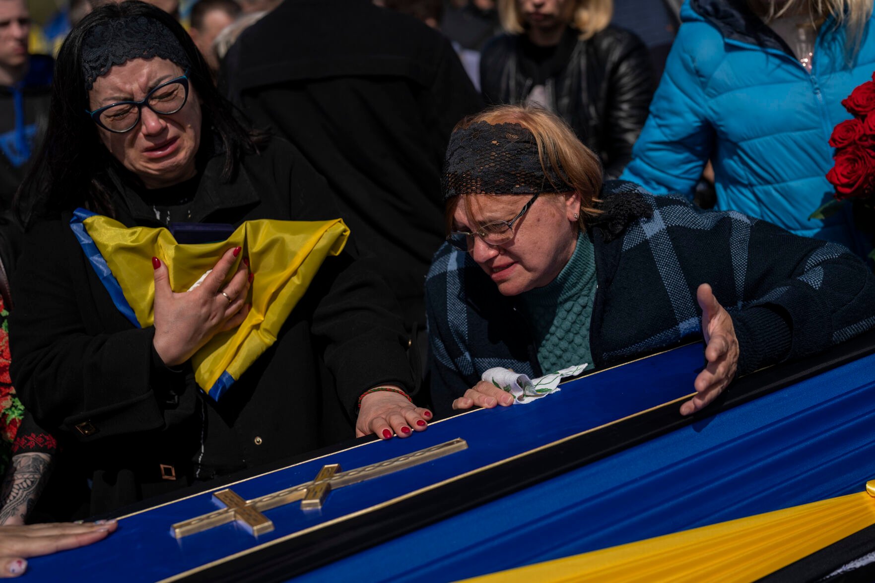 <p>Relatives mourn next to the coffin of Ukrainian serviceman Andrii Vorobiov on Monday at the Kryvyi Rih cemetery in eastern Ukraine.</p>