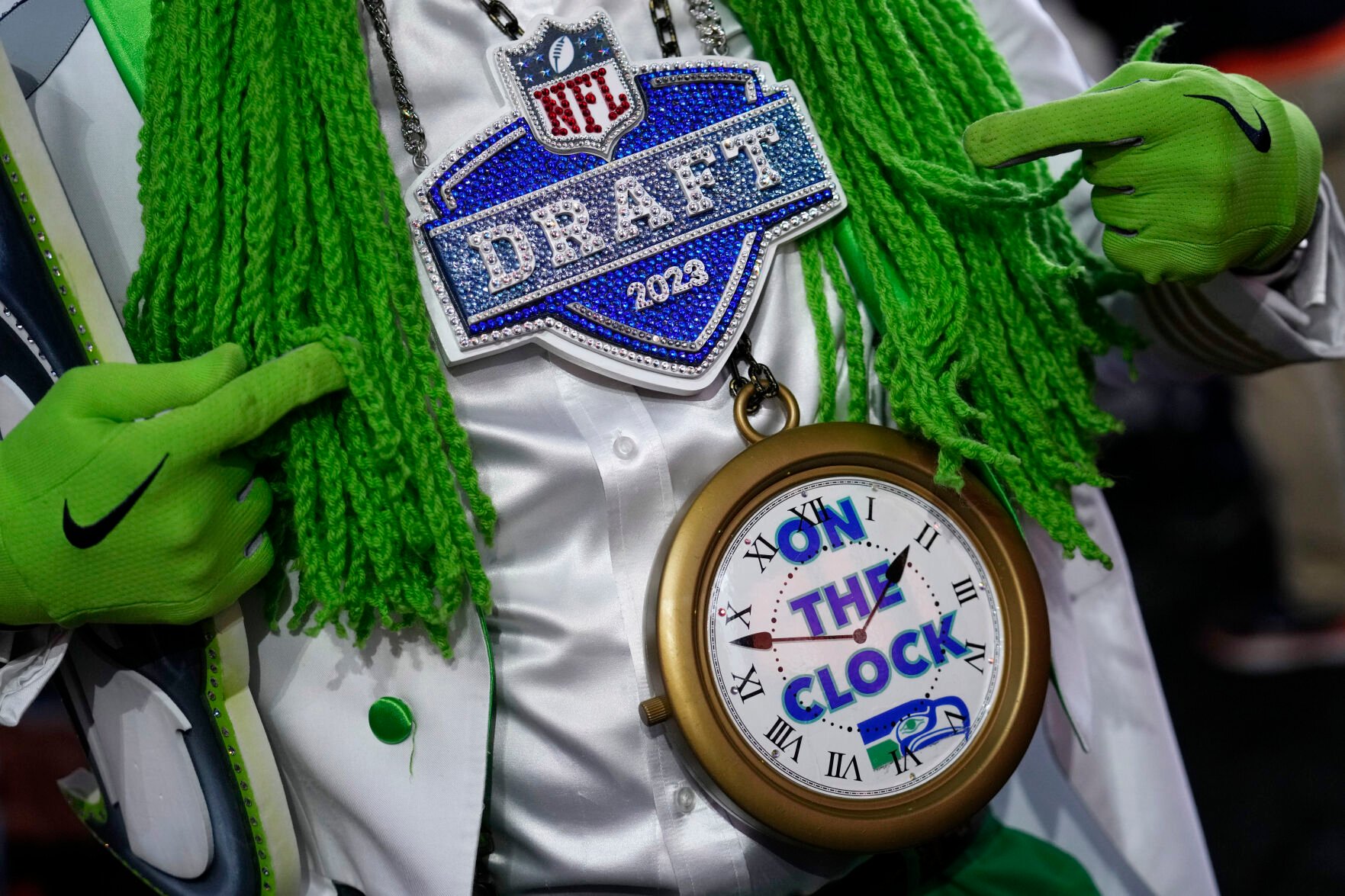 <p>A fan points to his necklace before the first round of the NFL football draft, Thursday, April 27, 2023, in Kansas City, Mo. (AP Photo/Jeff Roberson)</p>