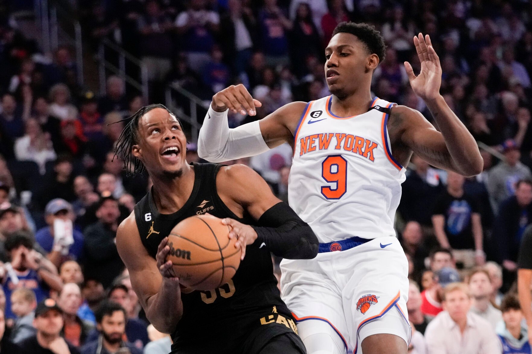 <p>Cleveland Cavaliers forward Isaac Okoro drives against New York Knicks guard RJ Barrett, right, during Sunday's Game 4 of their first-round playoff series at Madison Square Garden in New York.</p>