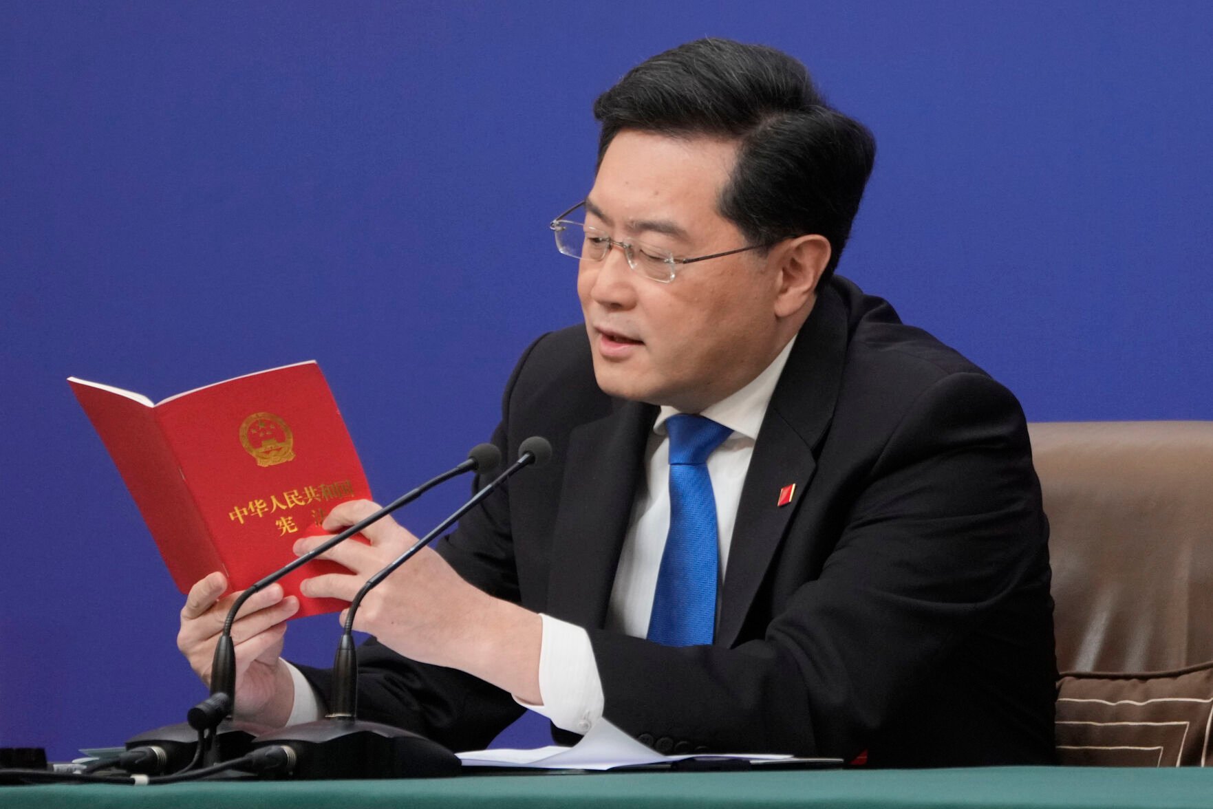 <p>Chinese Foreign Minister Qin Gang reads from the Chinese constitution when answering a question about Taiwan during a press conference held on the sidelines of the annual meeting of China's National People's Congress (NPC) on March 7 in Beijing. </p>