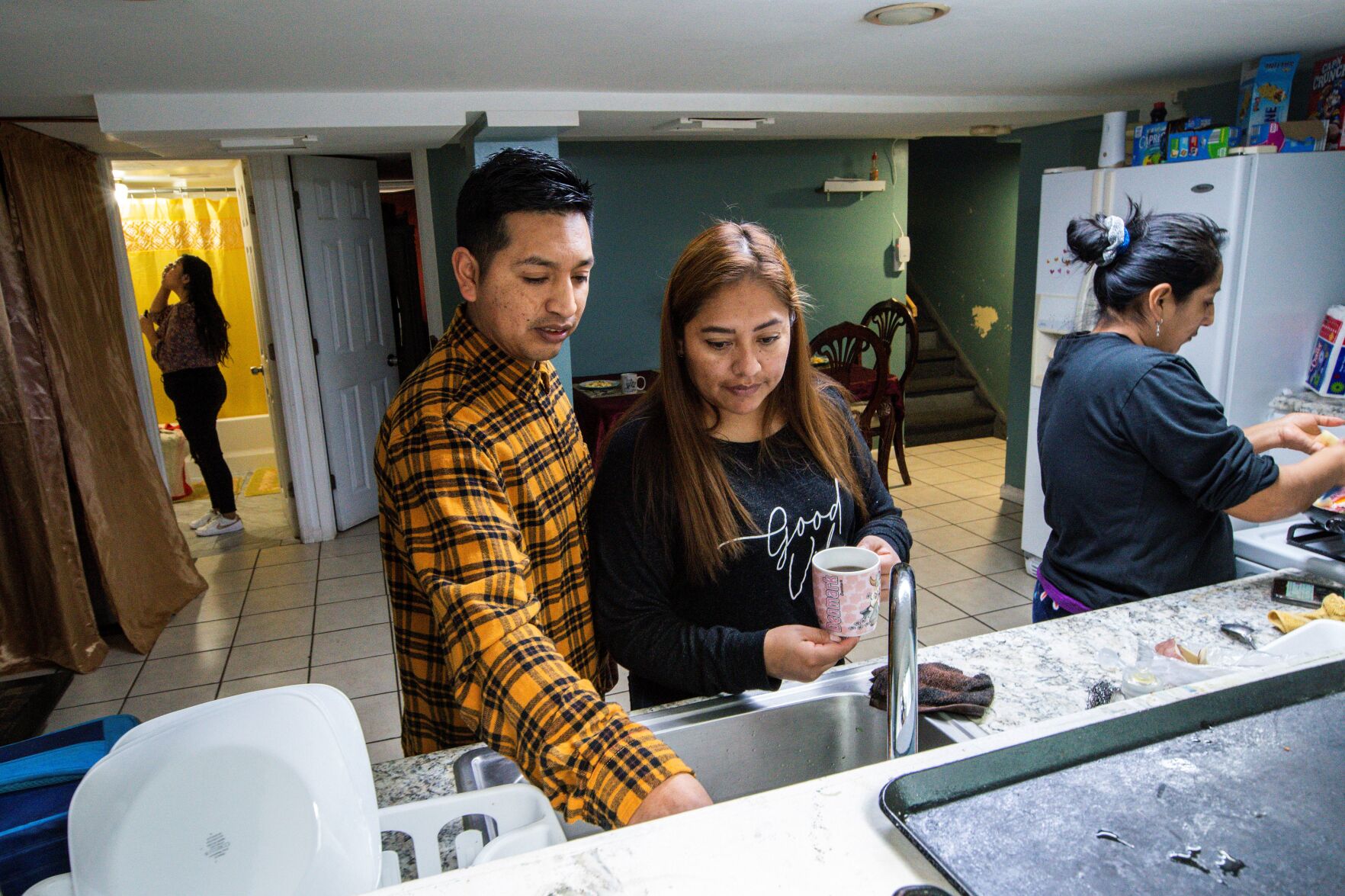 <p>Ecuadorian migrant Klever Ortega, left, and his wife, Cristina Lema, prepare breakfast for their family March. 3 in Spring Valley, N.Y.</p>