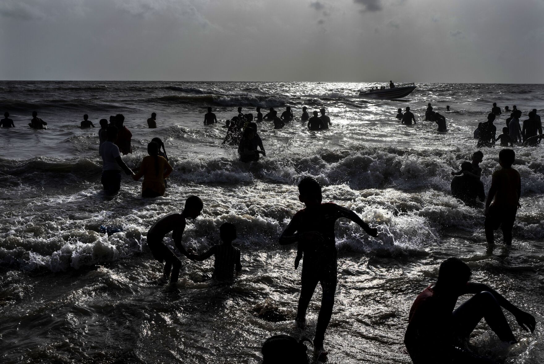 <p>FILE - Children play at a crowded Juhu beach on the Arabian Sea coast on a hot and humid day in Mumbai, India, May 22, 2022. Demographers are unsure exactly when India will take the title as the most populous nation in the world because they're relying on estimates to make their best guess. (AP Photo/Rafiq Maqbool, File)</p>