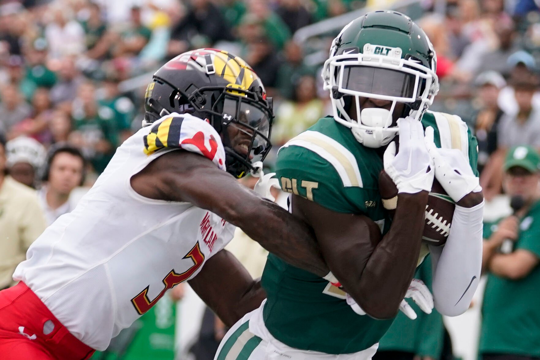 <p>Charlotte wide receiver Grant DuBose catches a touchdown pass in front of Maryland defensive back Deonte Banks during the first half of a Sept. 10 game in Charlotte, N.C.</p>