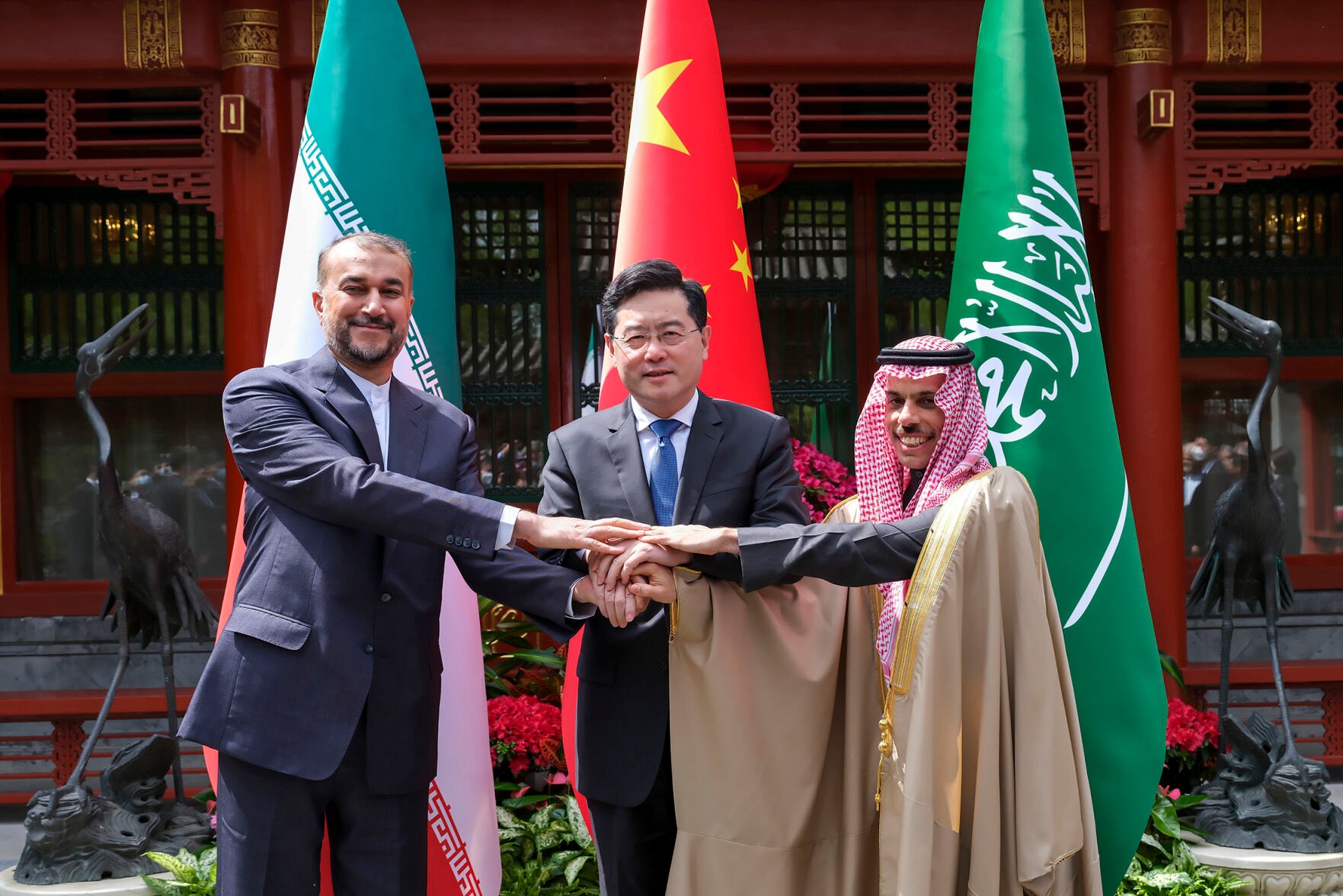 <p>Iran's Foreign Minister Hossein Amirabdollahian, left, holds hands with his Saudi Arabian counterpart Prince Faisal bin Farhan Al Saud, right, and Chinese counterpart Qin Gang on April 6 in Beijing.</p>