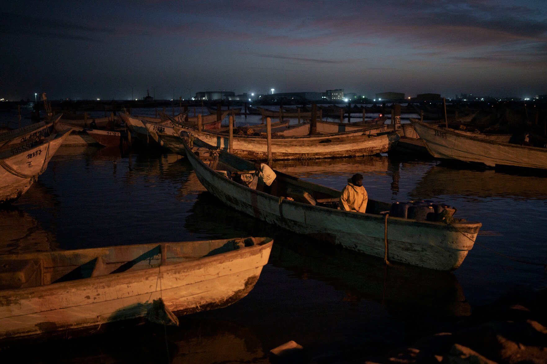<p>Fishermen aboard a traditional Mauritanian fishing boat, or pirogue, return after a day of work Nov. 27, 2021, to the port of Nouadhibou, Mauritania. Every year, hundreds if not thousands of West African migrants disappear trying to reach the Canary Islands and, they believed, better lives in Europe.</p>