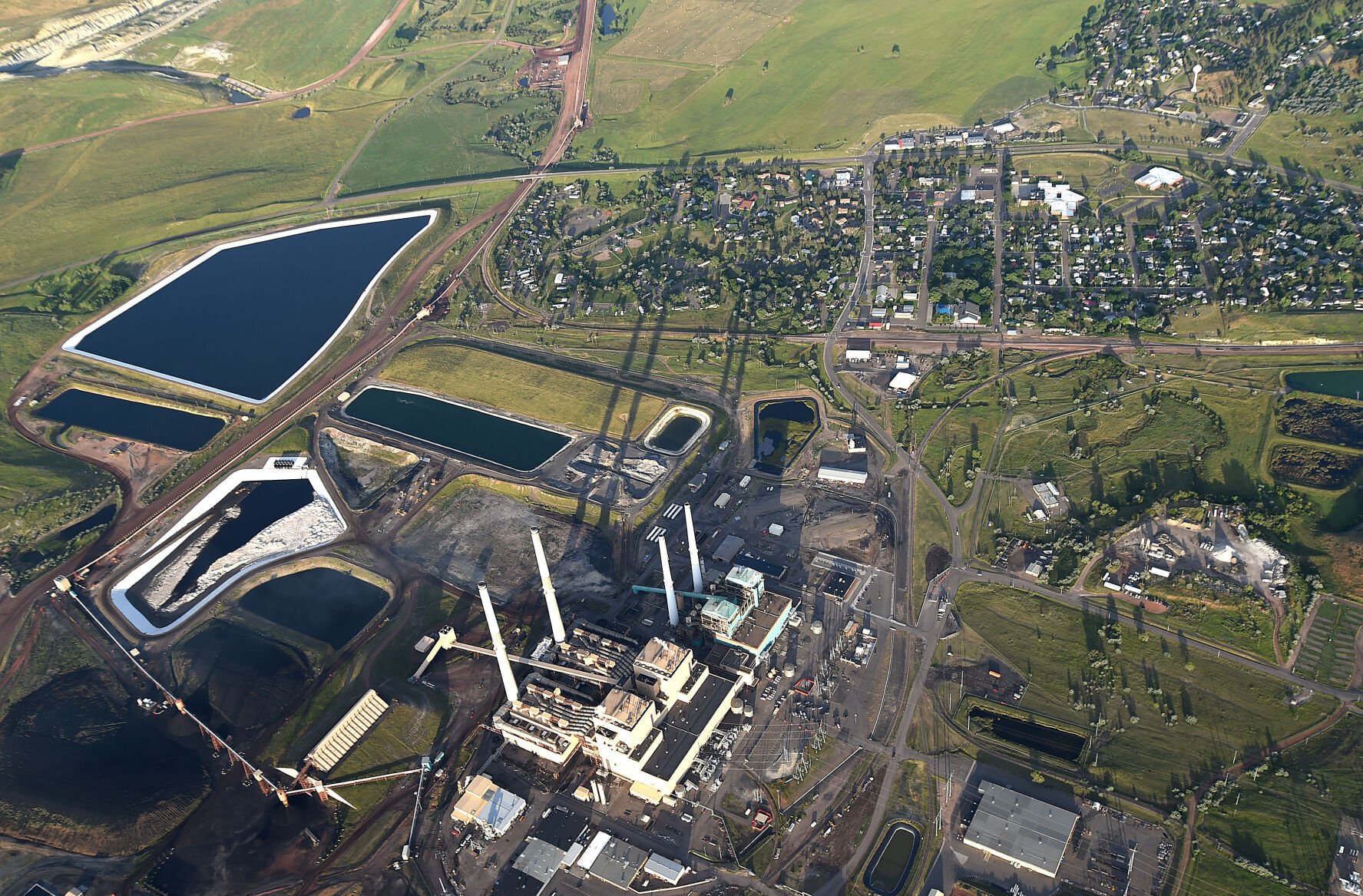 <p>An aerial view shows Colstrip units 1,2,3 and 4 as well as nearby industrial ponds.</p>