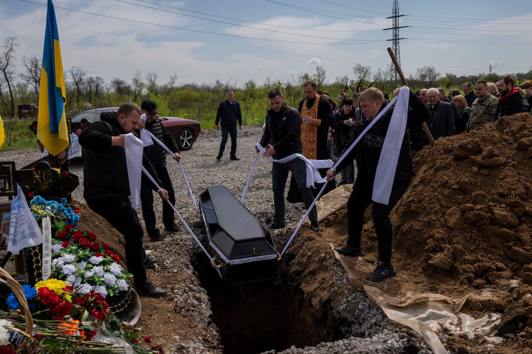 <p>Undertakers lower the coffin of Ukrainian serviceman Andrii Romanenko on Monday at the Kryvyi Rih cemetery in eastern Ukraine.</p>