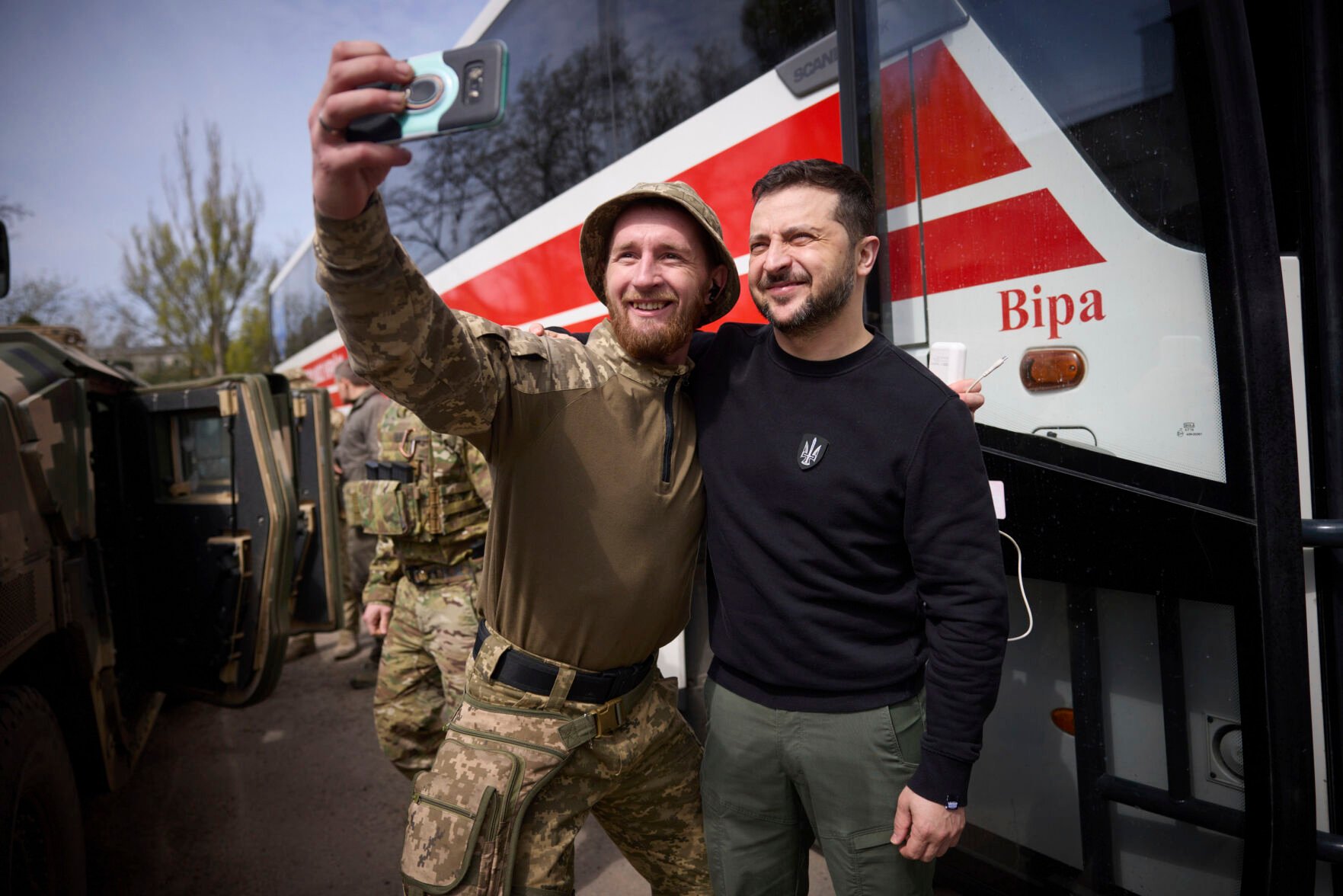 <p>Ukrainian President Volodymyr Zelenskyy poses for a selfie with a soldier Tuesday at a position in Avdiivka, Donetsk region, Ukraine.</p>