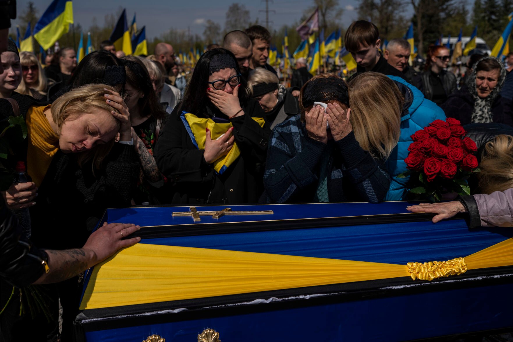 <p>Relatives mourn next to the coffin of Ukrainian serviceman Andrii Vorobiov on Monday at the Kryvyi Rih cemetery in eastern Ukraine.</p>