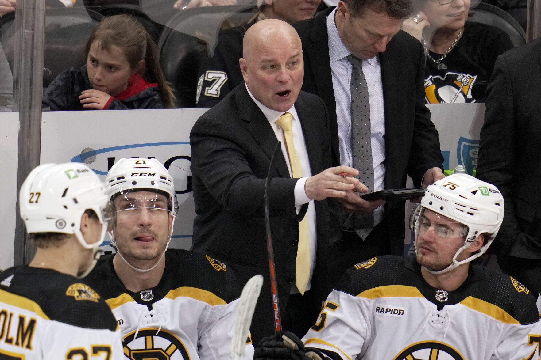<p>Boston Bruins head coach Jim Montgomery gives instructions during the first period of an April 1 game against the Pittsburgh Penguins in Pittsburgh.</p>