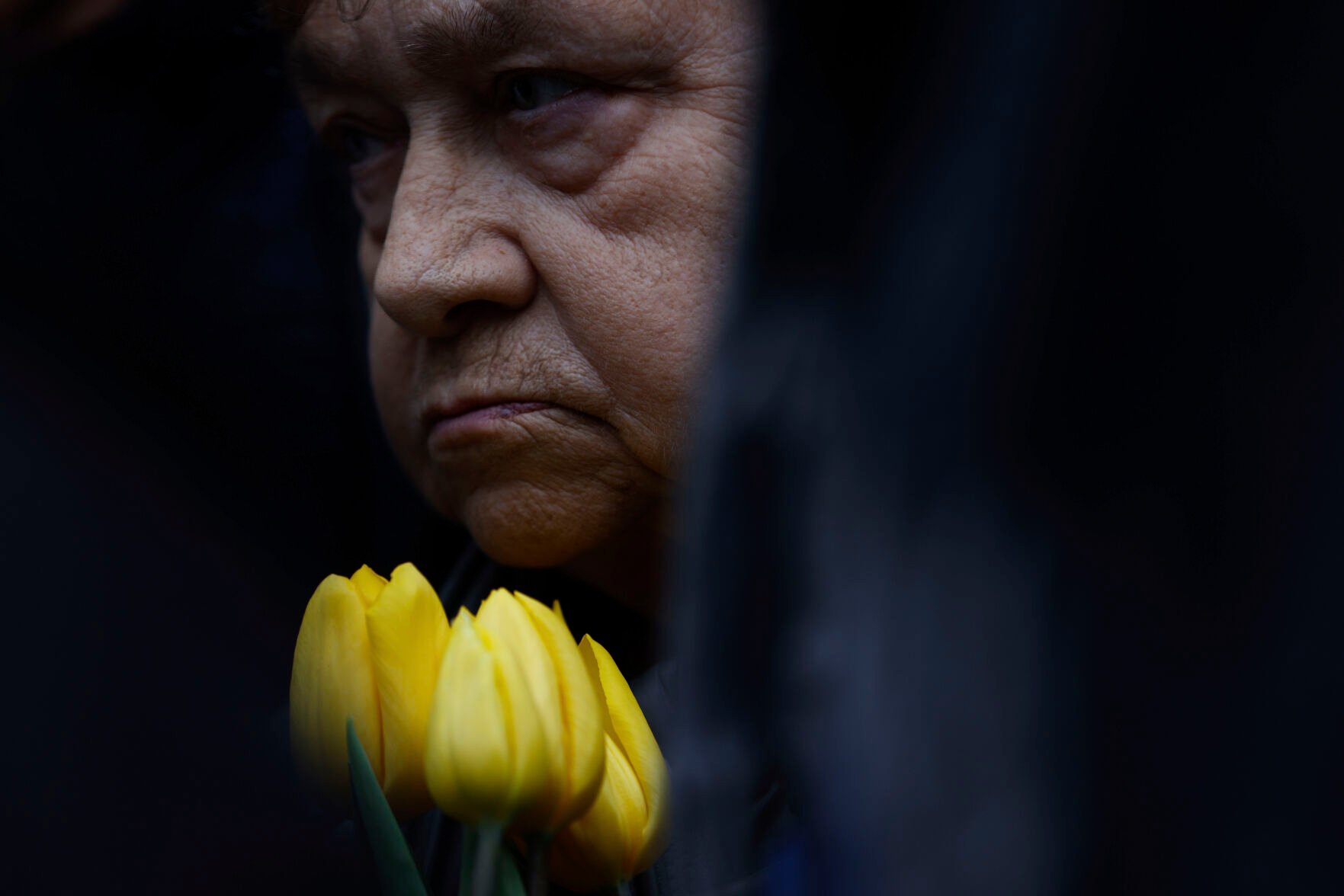 <p>A woman holds yellow tulips during personal unofficial observances marking the 80th anniversary of the Warsaw Ghetto Uprising in Warsaw, Poland, Wednesday, April 19, 2023. (AP Photo/Michal Dyjuk)</p>