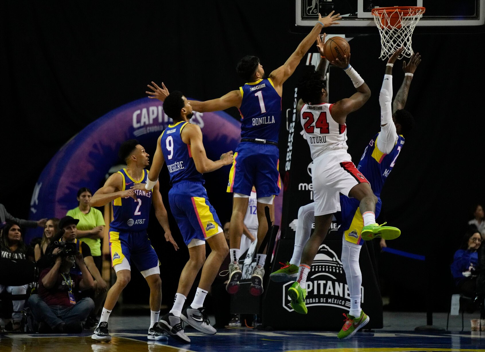 <p>Mexico City Capitanes' Gael Bonilla works to block a shot by Windy City Bulls' Daniel Oturu during an NBA G-League game, March 12, in Mexico City.</p>