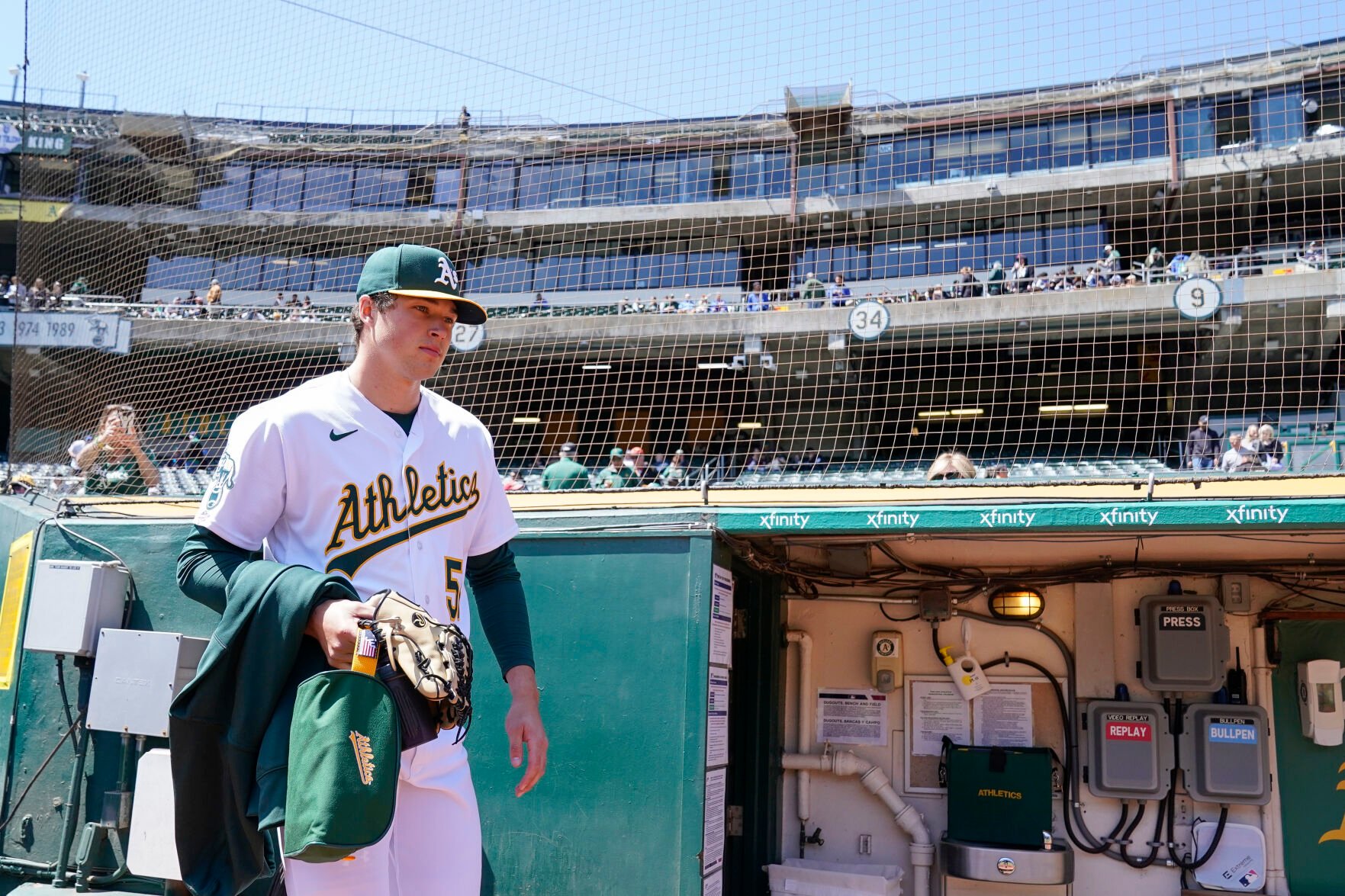<p>Oakland pitcher Mason Miller takes the field to warm up before a sparse crowd at Oakland Coliseum on Wednesday.</p>