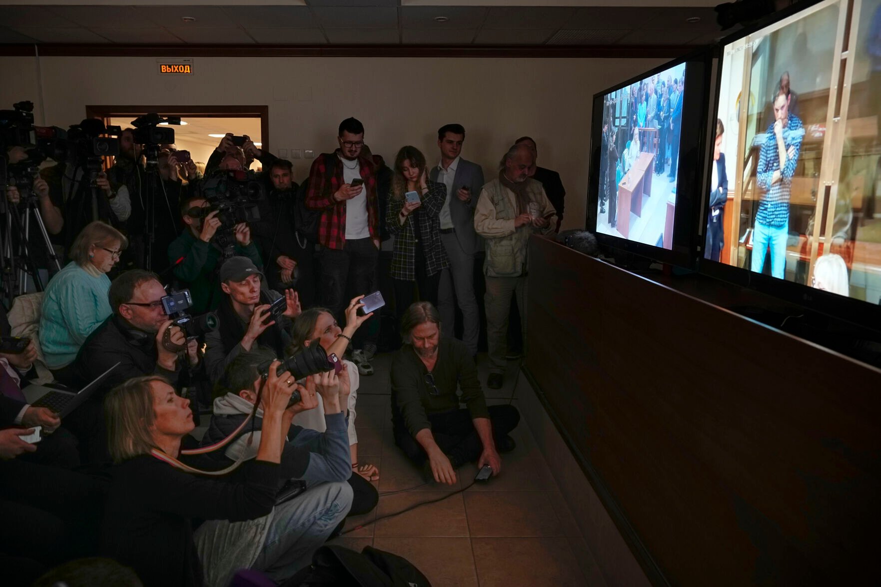 <p>Journalists watch a TV screen broadcasting a hearing Tuesday on Wall Street Journal reporter Evan Gershkovich's case from a courtroom at the Moscow City Court.</p>