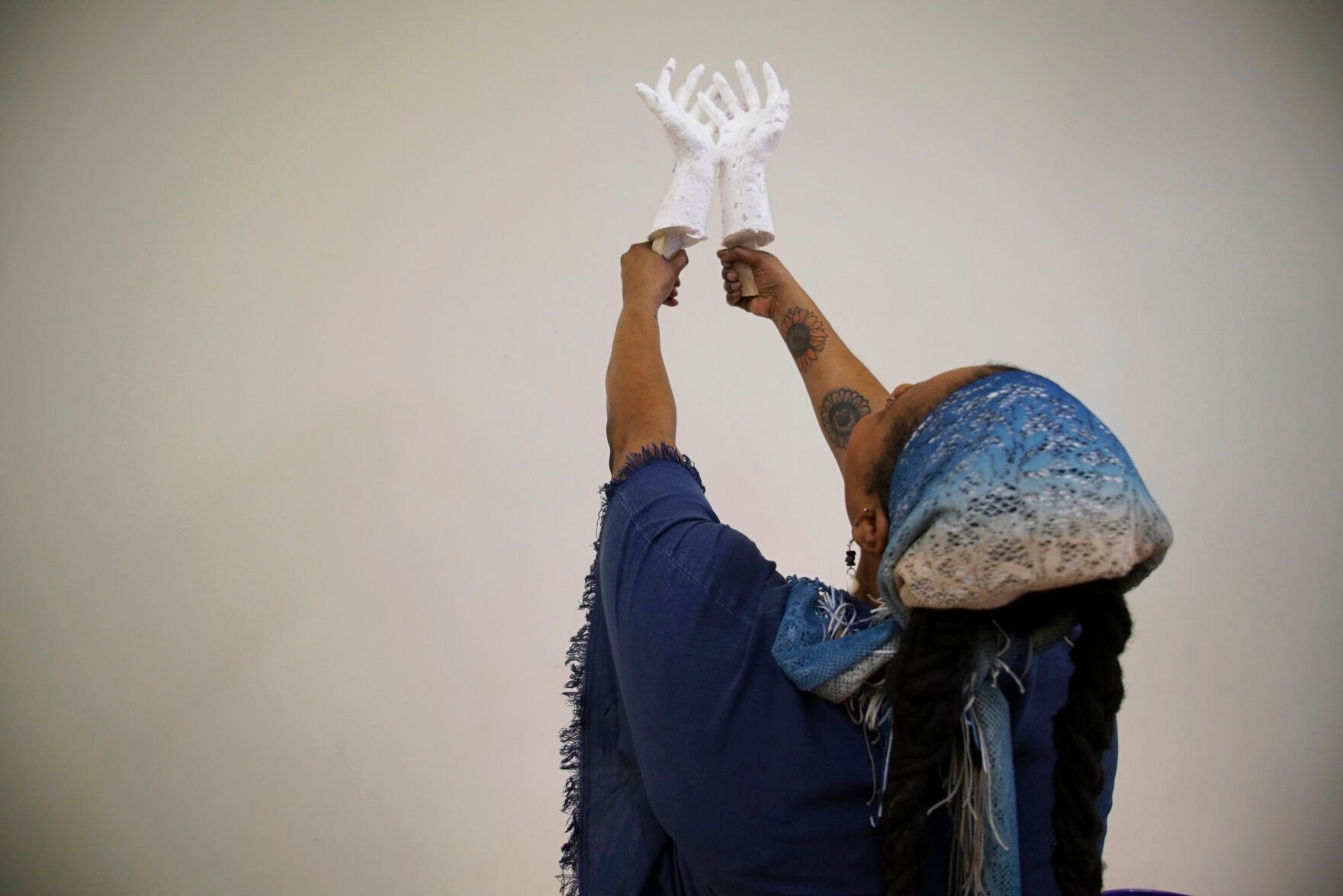 <p>Crystal Kornickey holds up casts of her hands in a studio Feb. 16 at the Gibbes Museum of Art in Charleston, S.C. She is one of 36 people whose hands will be cast in bronze for a memorial to the likely enslaved people discovered in an unmarked burial ground. In recent decades, advances in DNA research have allowed scientists to use ancient remains to peer into the lives of long-dead people. In Charleston, that's meant tracing some of the African roots that were cut off by slavery.</p>
