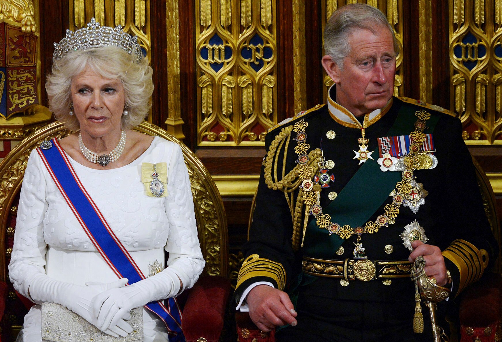 <p>Britain's Prince Charles, right, and Camilla, Duchess of Cornwall, listen as Britain's Queen Elizabeth II delivers the Queen's Speech on June 4, 2014, in the House of Lords during the State Opening of Parliament at the Palace of Westminster in London.</p>
