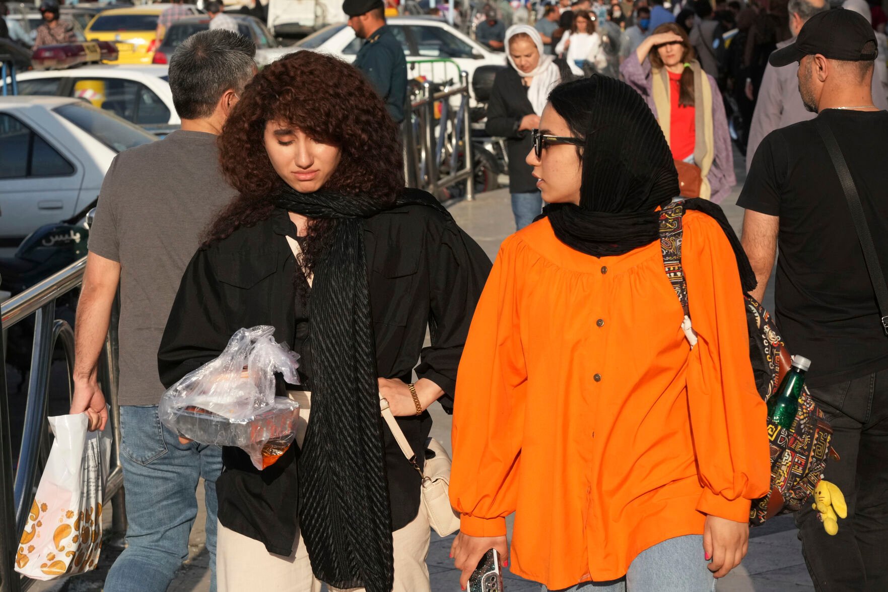 <p>A woman walks around Tajrish commercial district without wearing her mandatory Islamic headscarf April 29 in northern Tehran, Iran. </p>