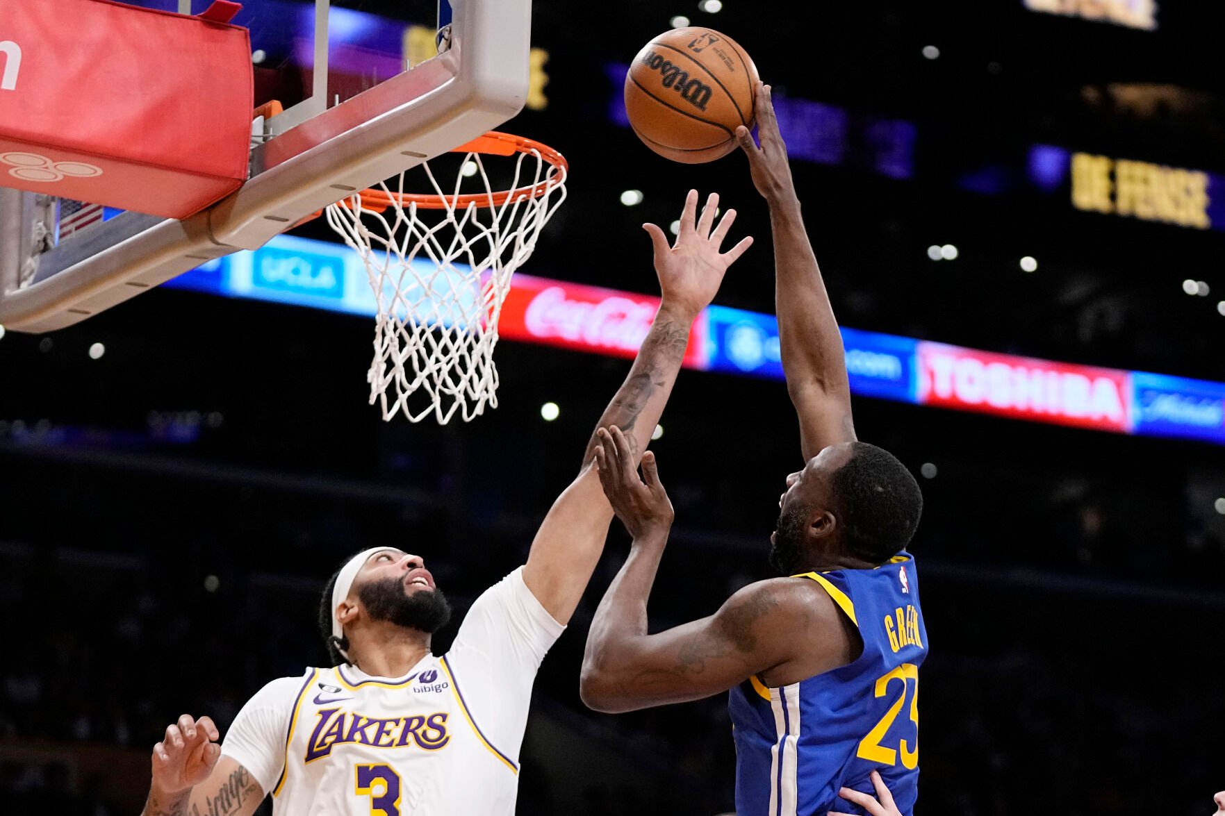 <p>Warriors forward Draymond Green, right, shoots as Lakers forward Anthony Davis defends during the first half of Saturday's  Western Conference semifinal game in Los Angeles.</p>