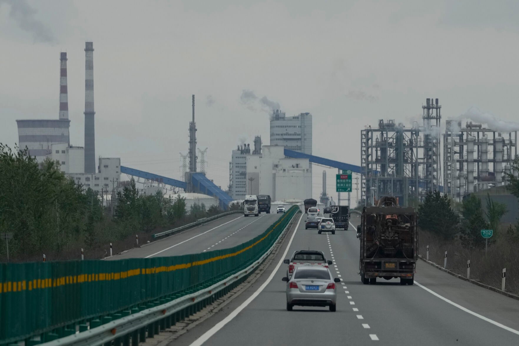 <p>Smoking chimneys are seen along a highway in a coal producing region in Yulin in northwestern China's Shaanxi province on April 24.</p>
