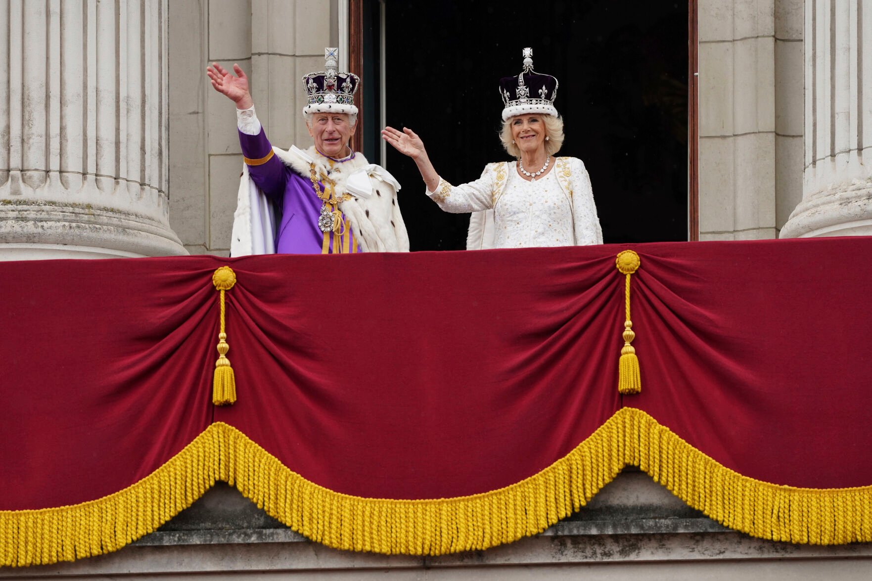 <p>King Charles III and Queen Camilla wave from the balcony of Buckingham Palace on Saturday in London.</p>