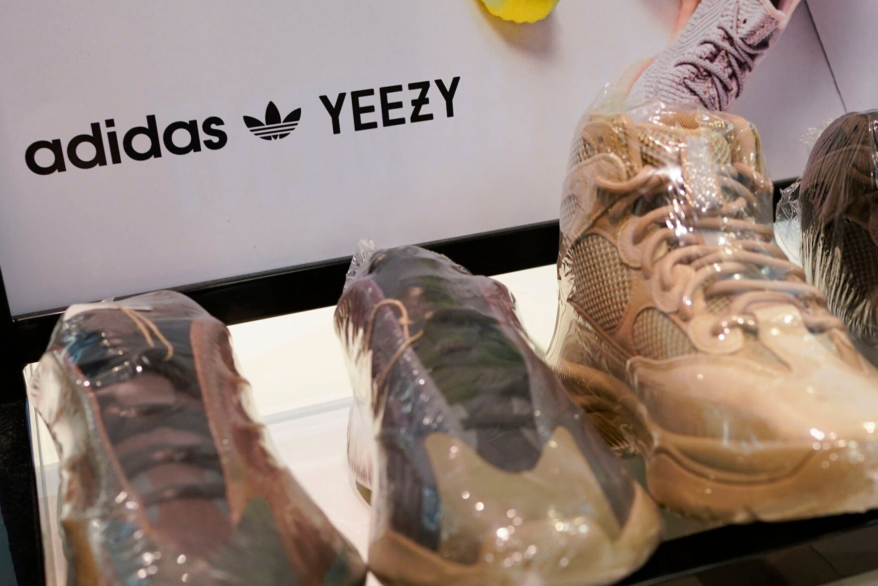 <p>A sign advertises Yeezy shoes made by Adidas at Kickclusive, a sneaker resale store, Oct. 25 in Paramus, N.J.</p>