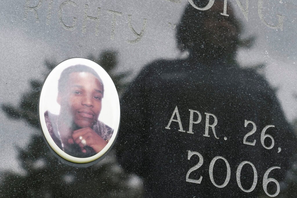 <p>Posing for a photo at a cemetery in Poughkeepsie, N.Y., April 19, 2023, Debra Long is reflected on the gravestone of her son, Randy Long, who was murdered in 2006. An AP examination of data from 23 states shows that Black people are disproportionately denied aid from programs that reimburse victims of violent crime. (AP Photo/Seth Wenig)</p>